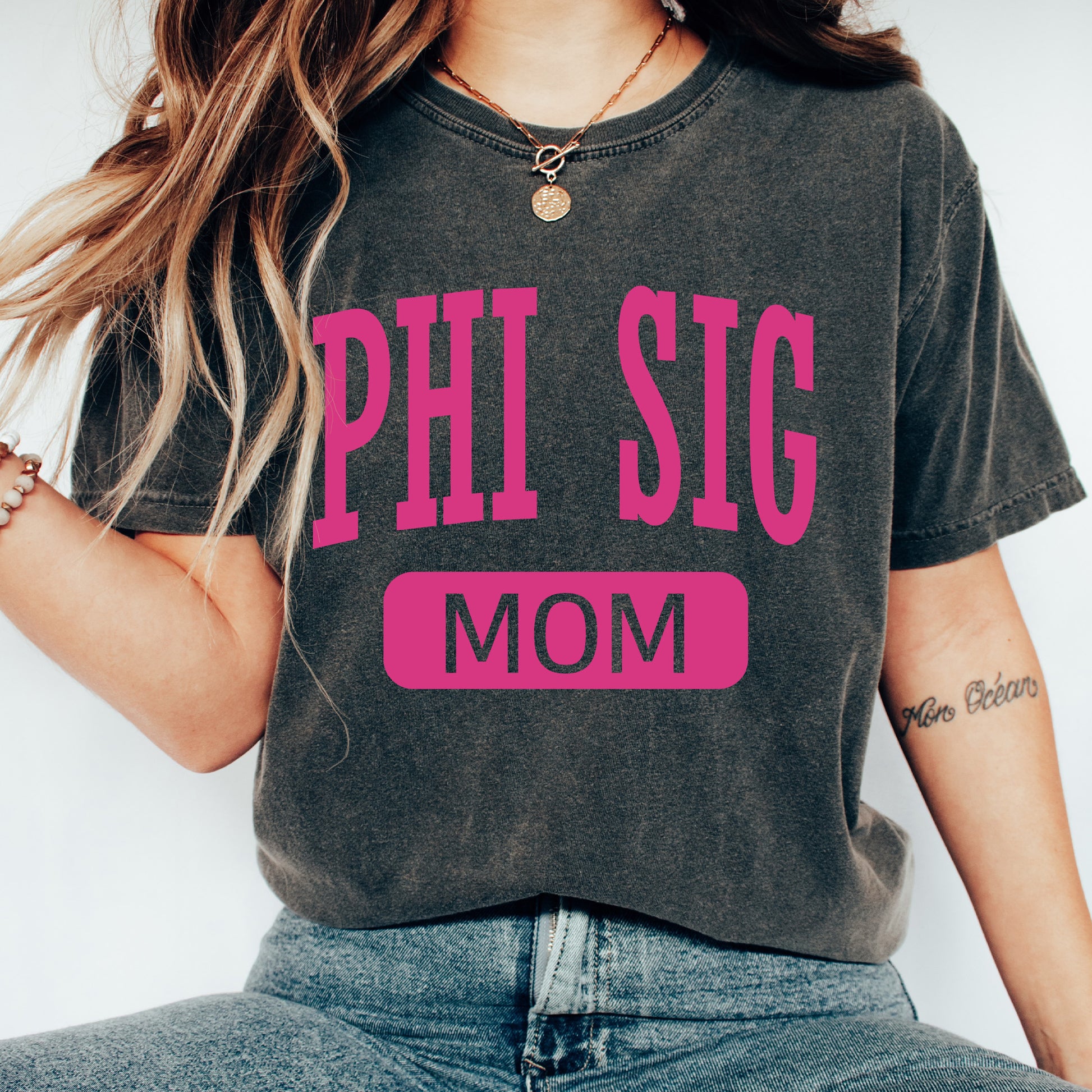 a woman wearing a phi sig mom shirt