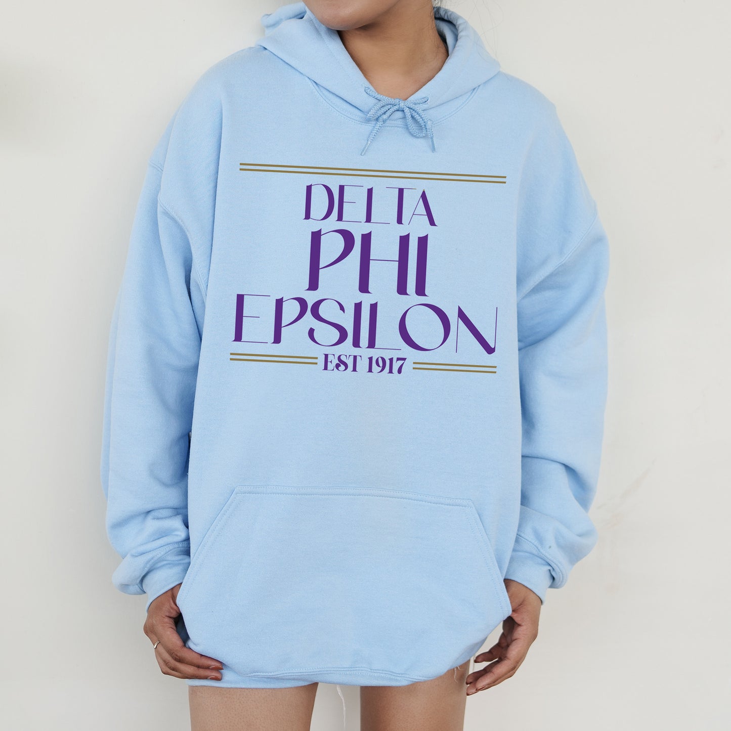 a person wearing a blue hoodie that says delta phi epsion