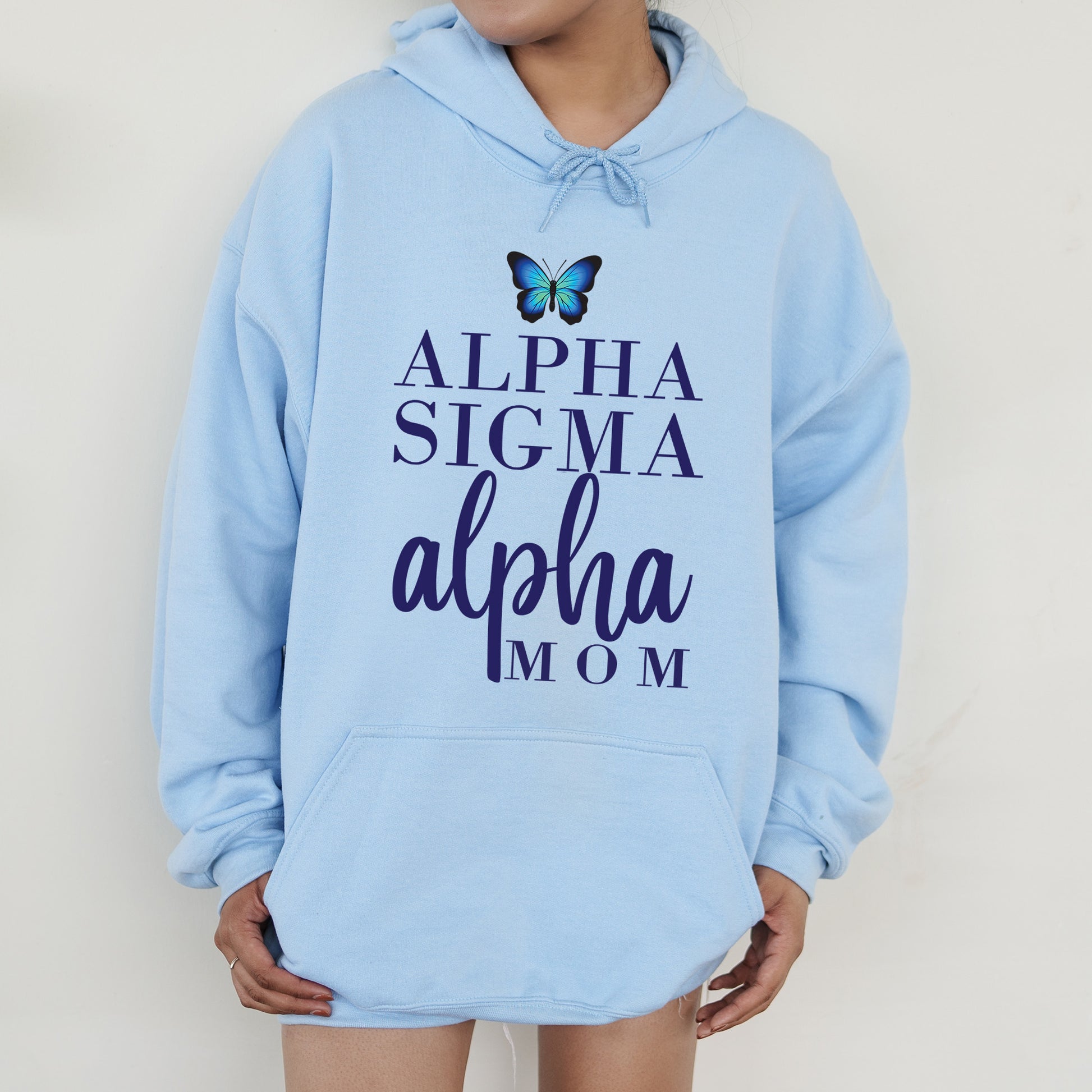 a woman wearing a blue sweatshirt with a butterfly on it