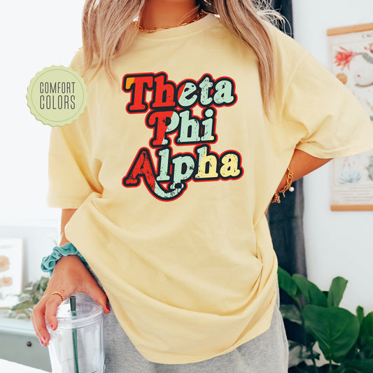 a woman wearing a yellow t - shirt that says, thea phi alpha