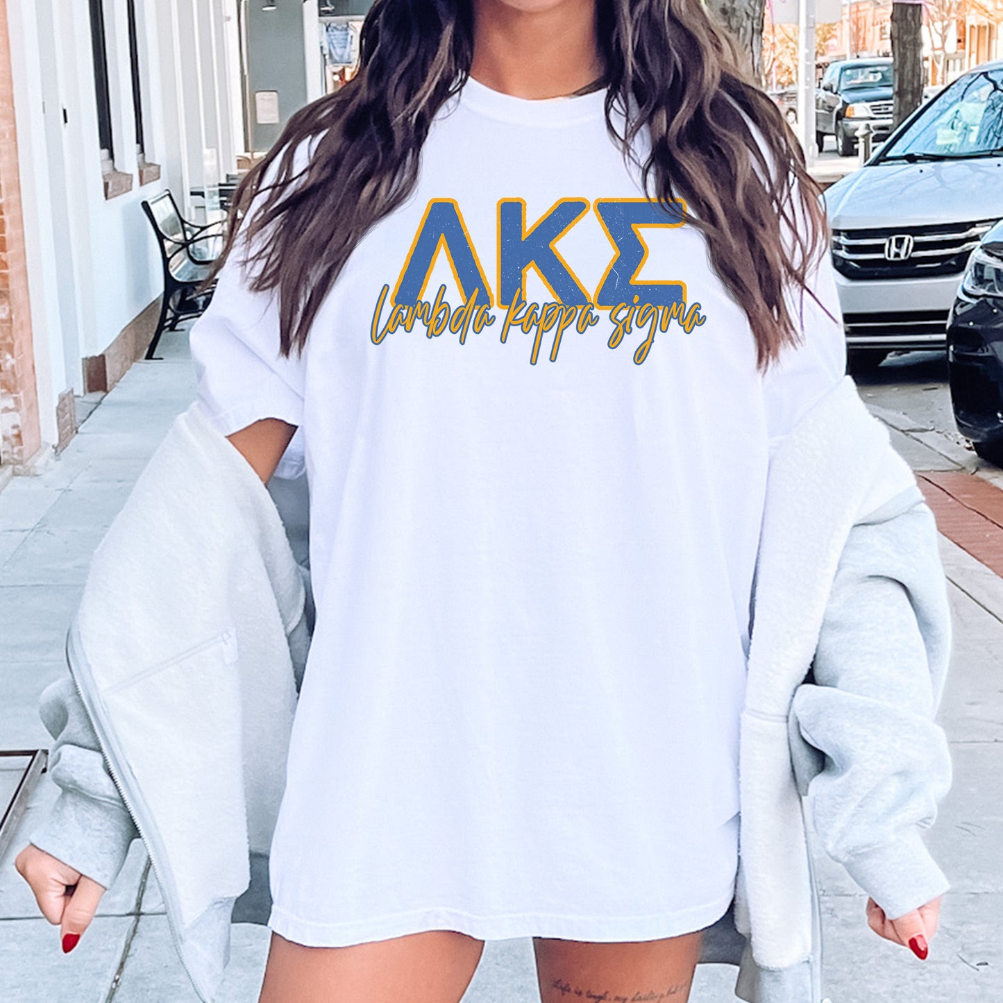 a woman wearing a white shirt with the letters ake on it
