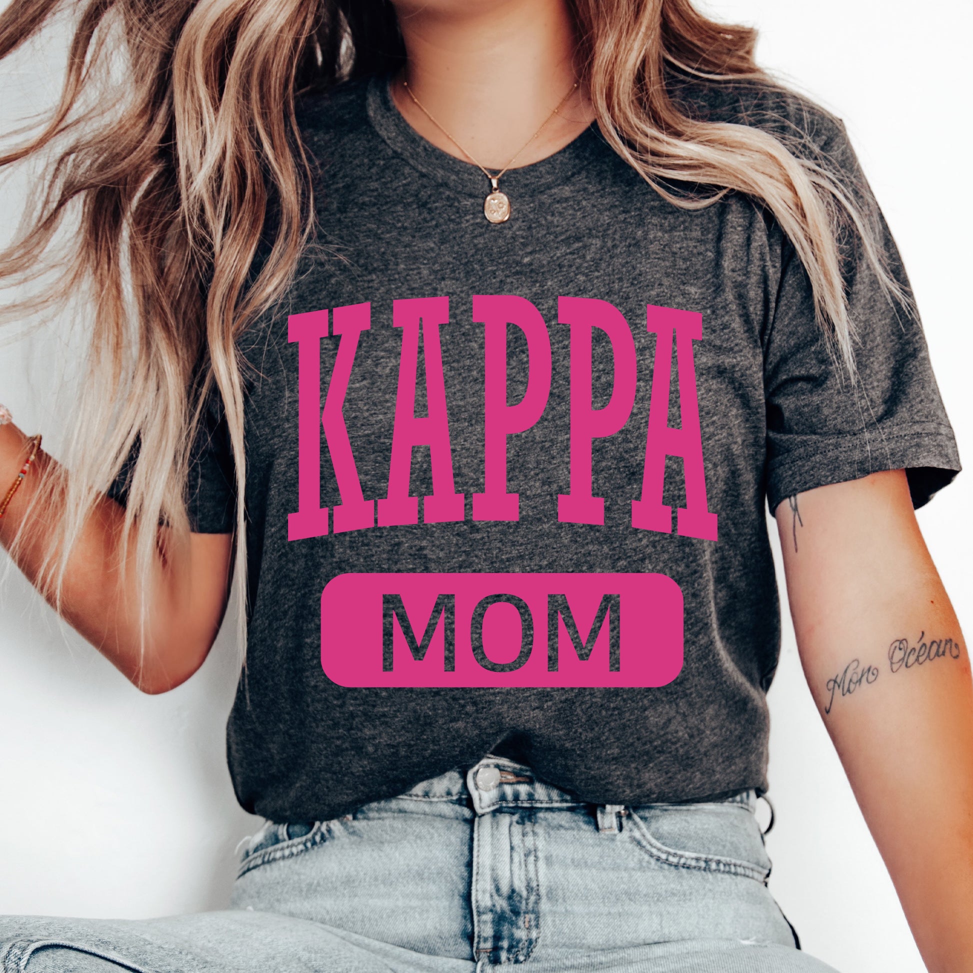 a woman wearing a t - shirt that says kappa mom