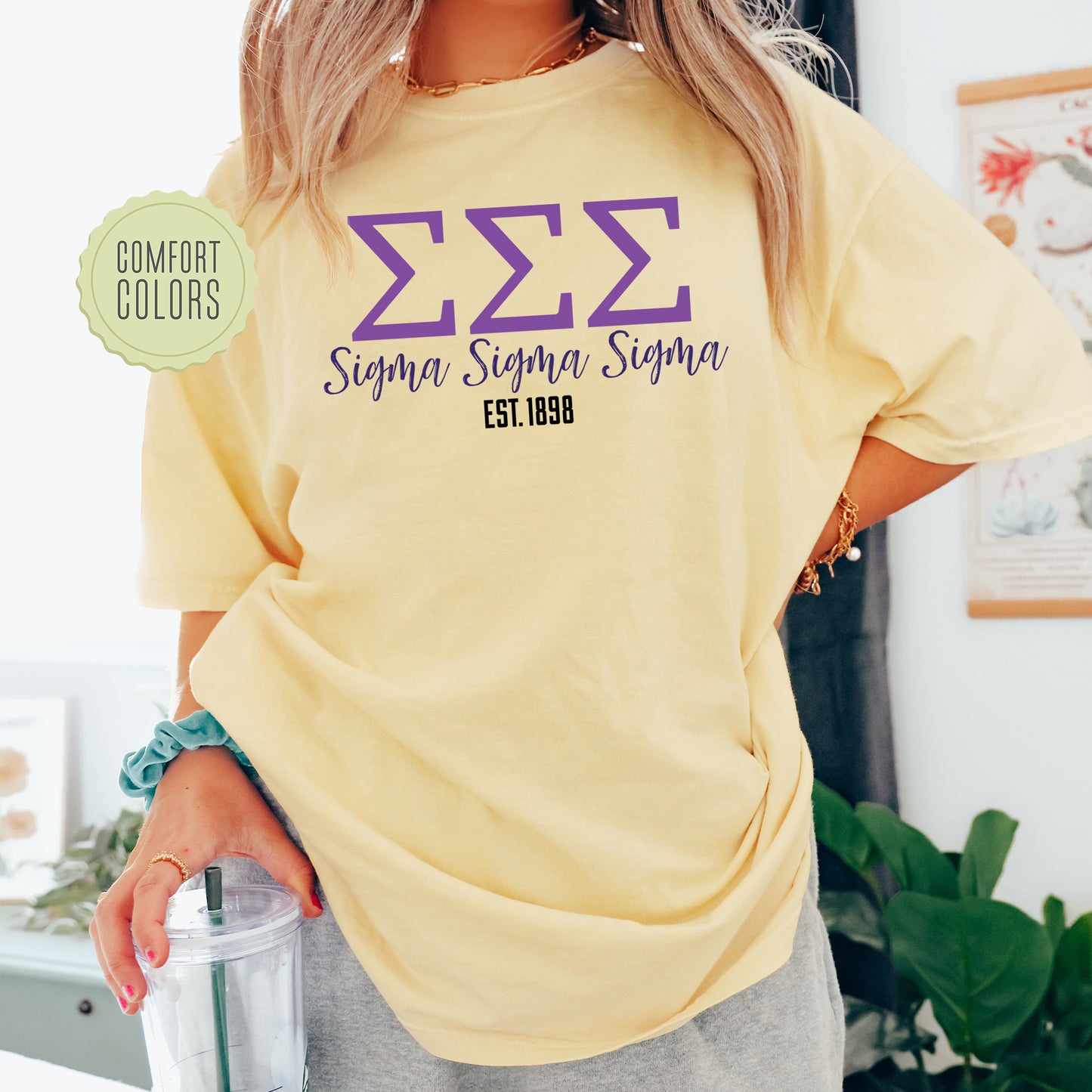 a woman in a yellow shirt holding a blender