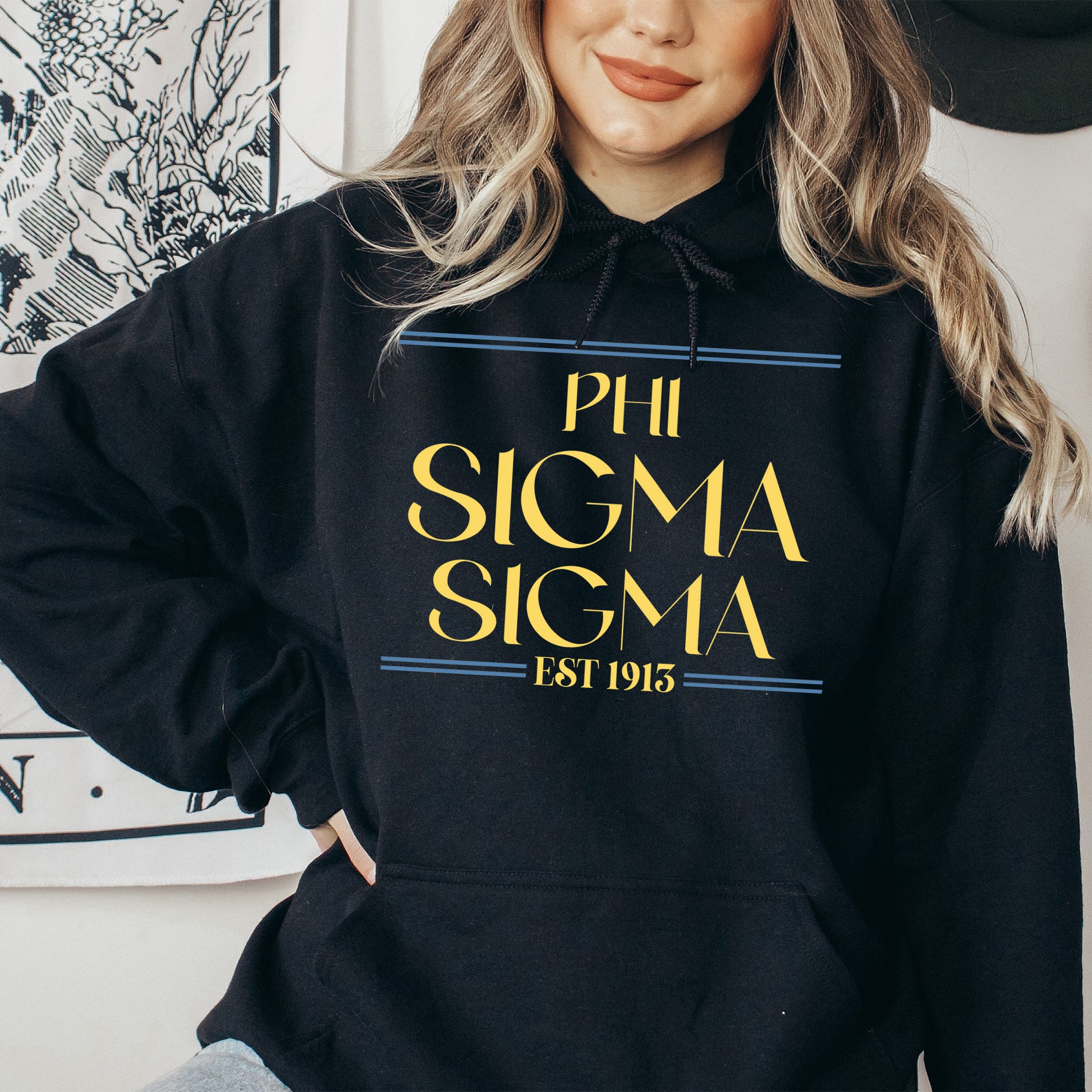 a woman wearing a black pullover sweatshirt with the word phi sigma stigma