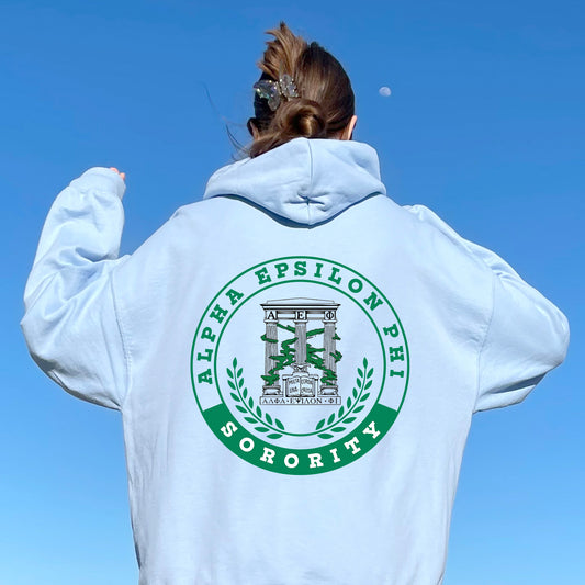 a woman in a white hoodie is flying a kite