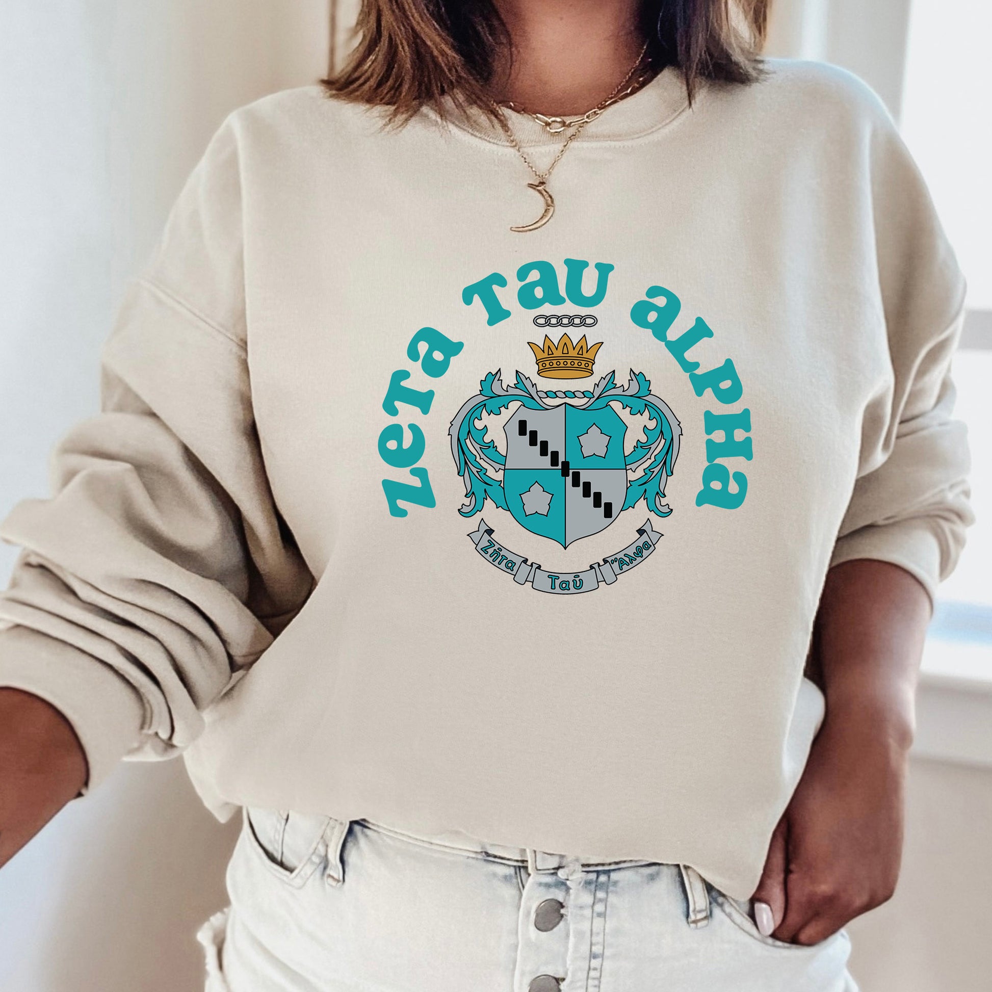 a woman wearing a sweatshirt with a crest on it