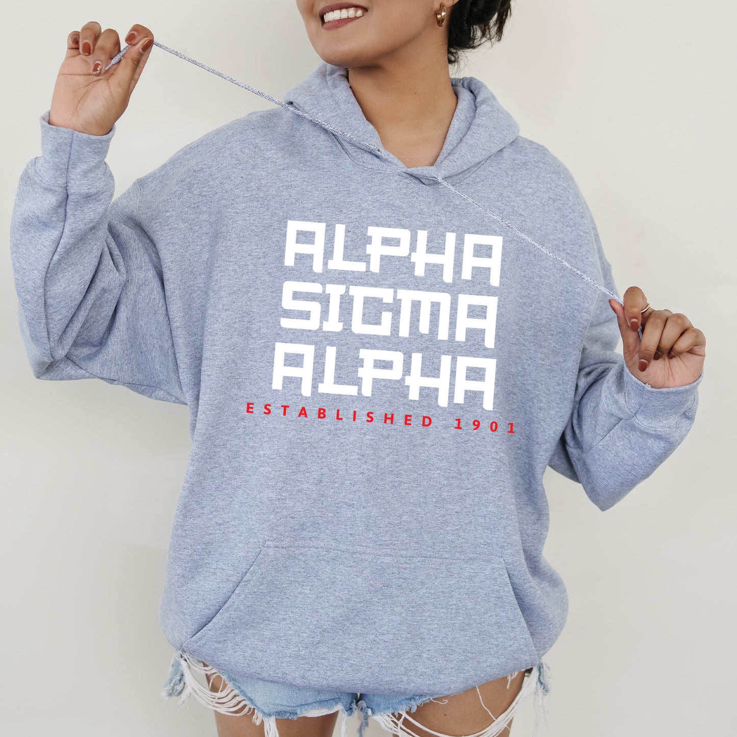 a woman in a blue hoodie is holding a toothbrush