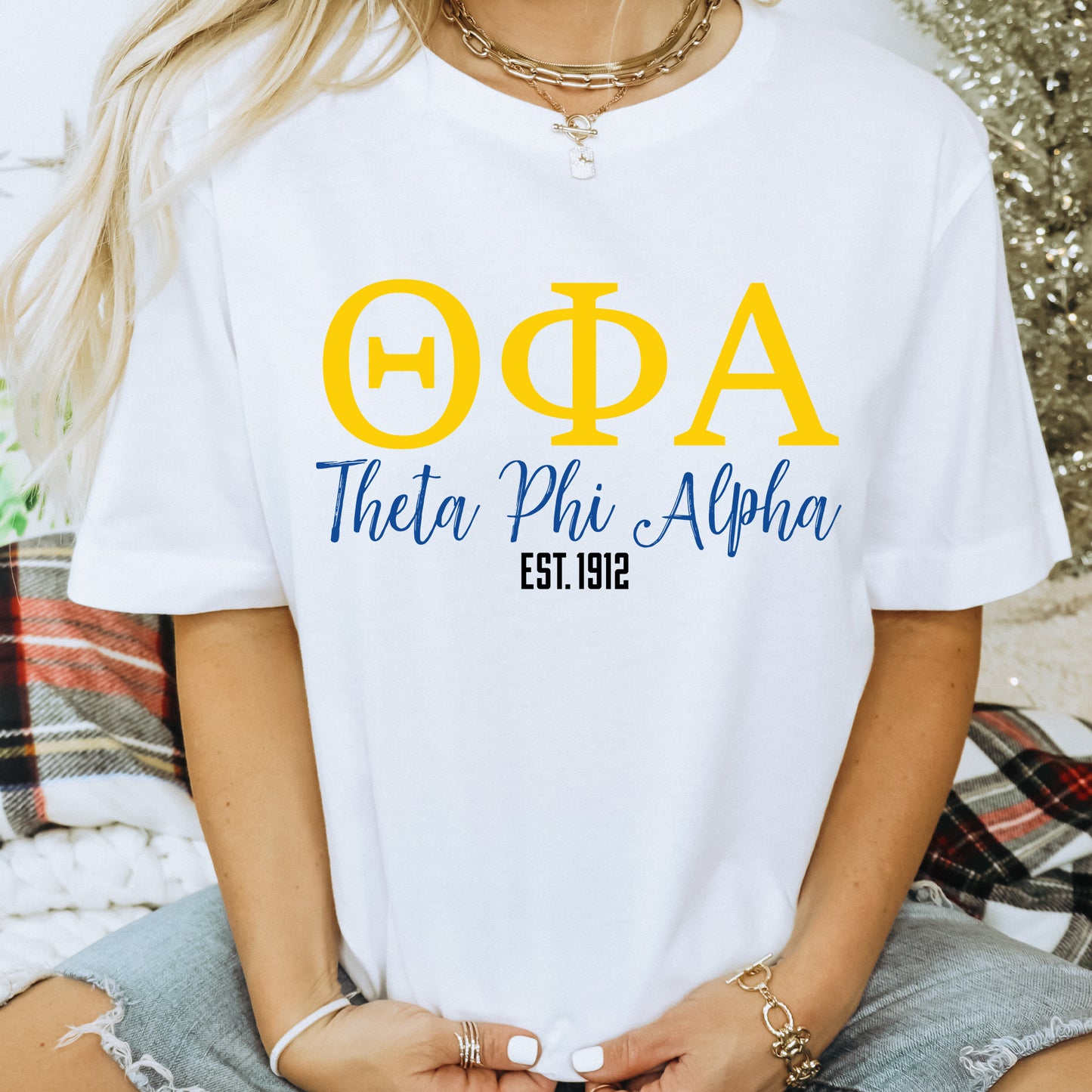 a woman wearing a white phi phi shirt