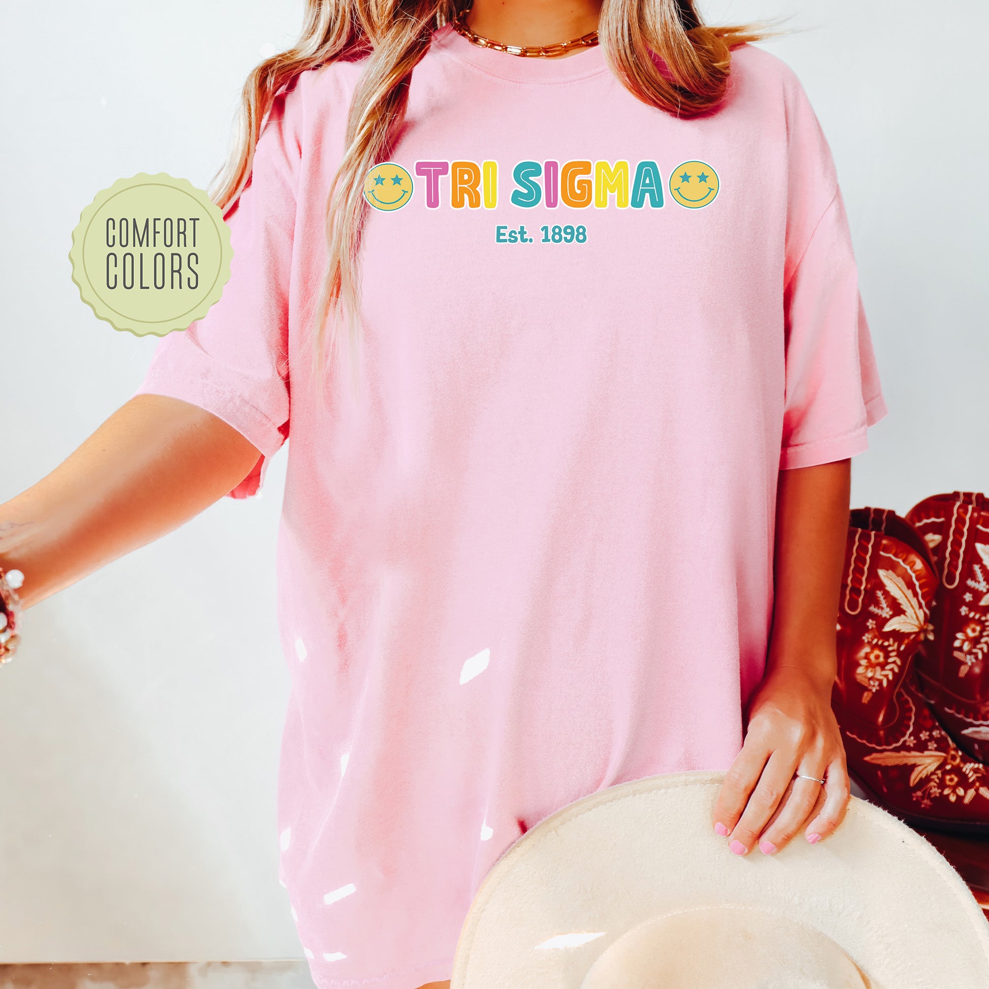 a woman wearing a pink shirt and hat