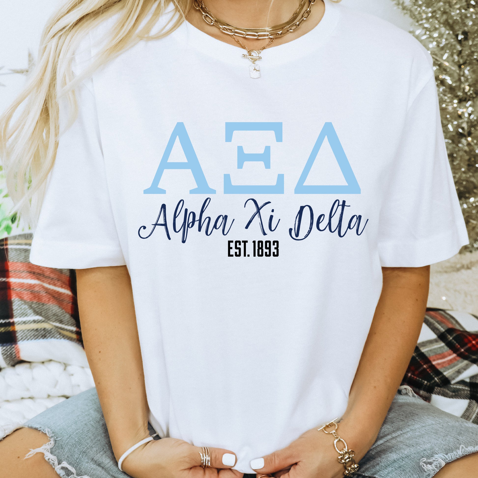a woman sitting on the ground wearing a t - shirt that says aea