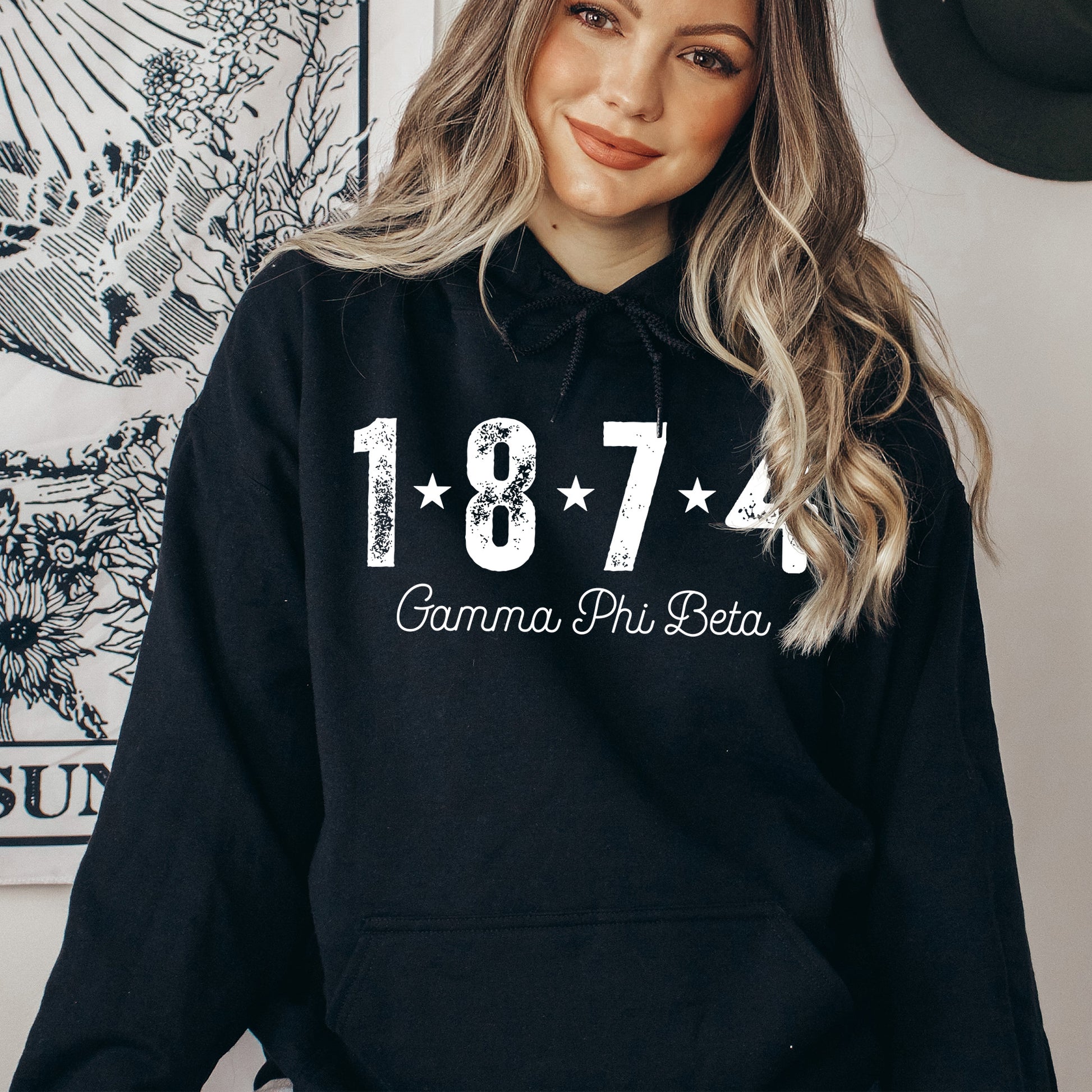 a woman wearing a black hoodie with the number seventy on it