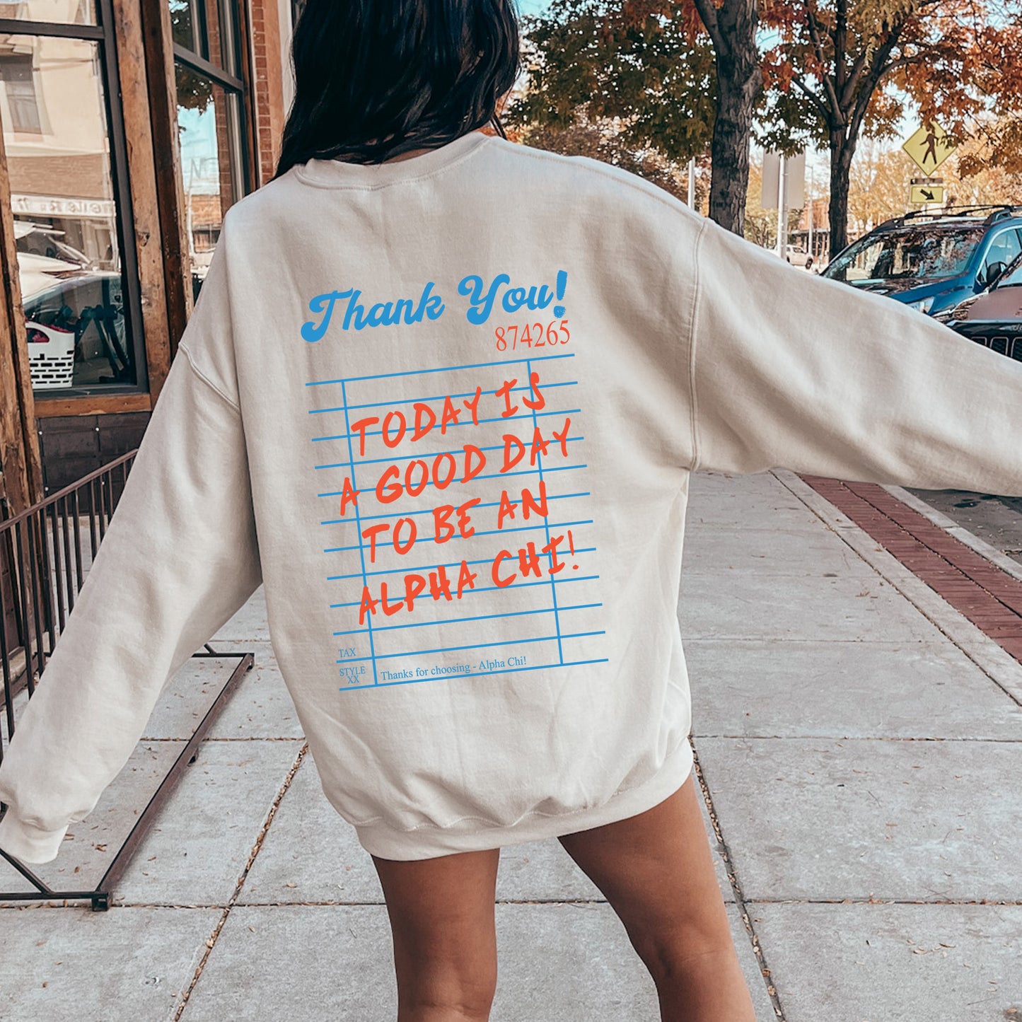 a woman is walking down the sidewalk with her back to the camera
