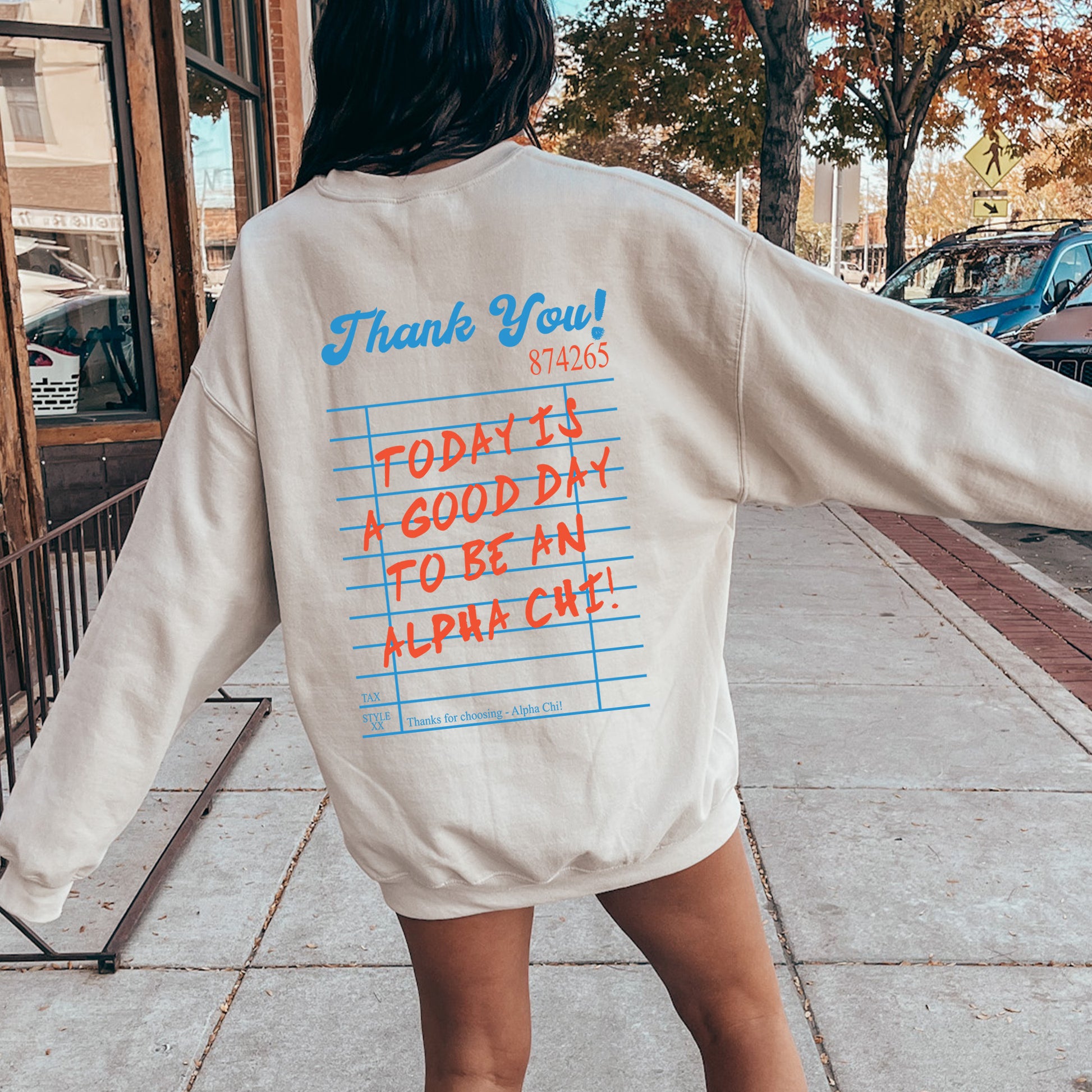 a woman is walking down the sidewalk with her back to the camera