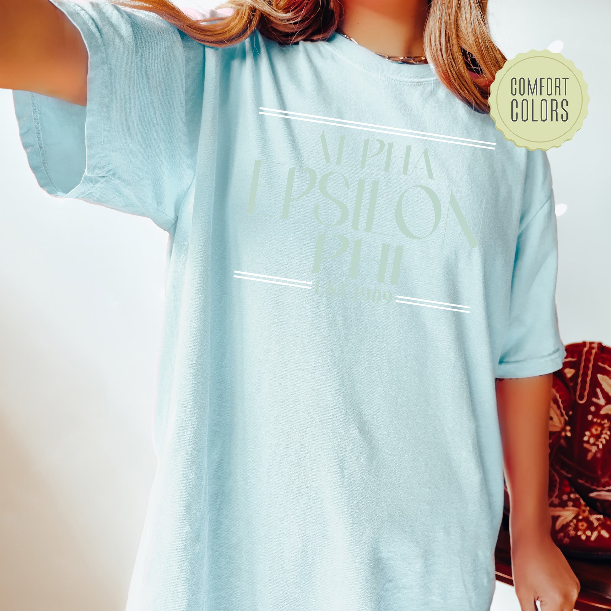 a woman wearing a light blue shirt with the words applied on it