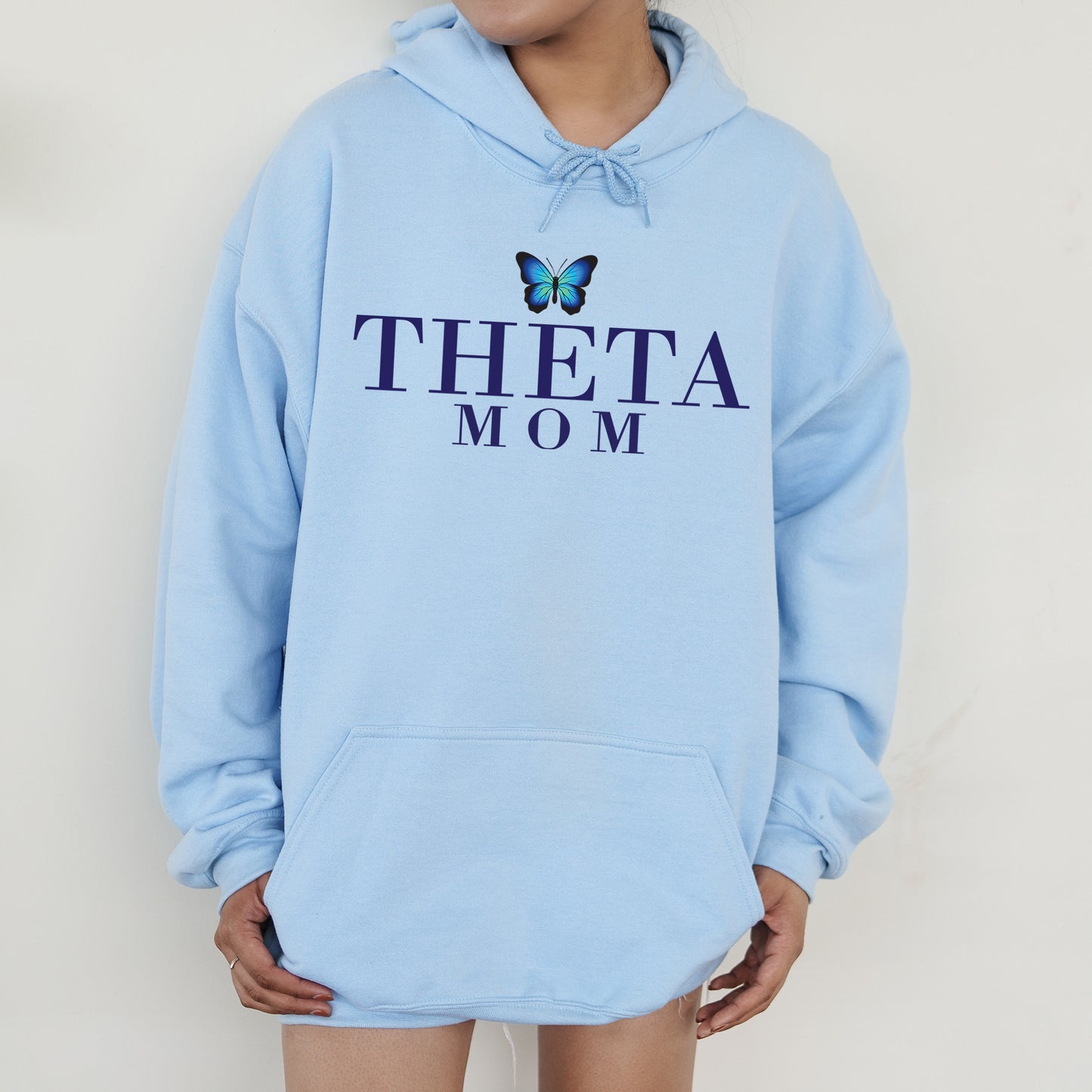 a woman wearing a blue hoodie with a butterfly on it