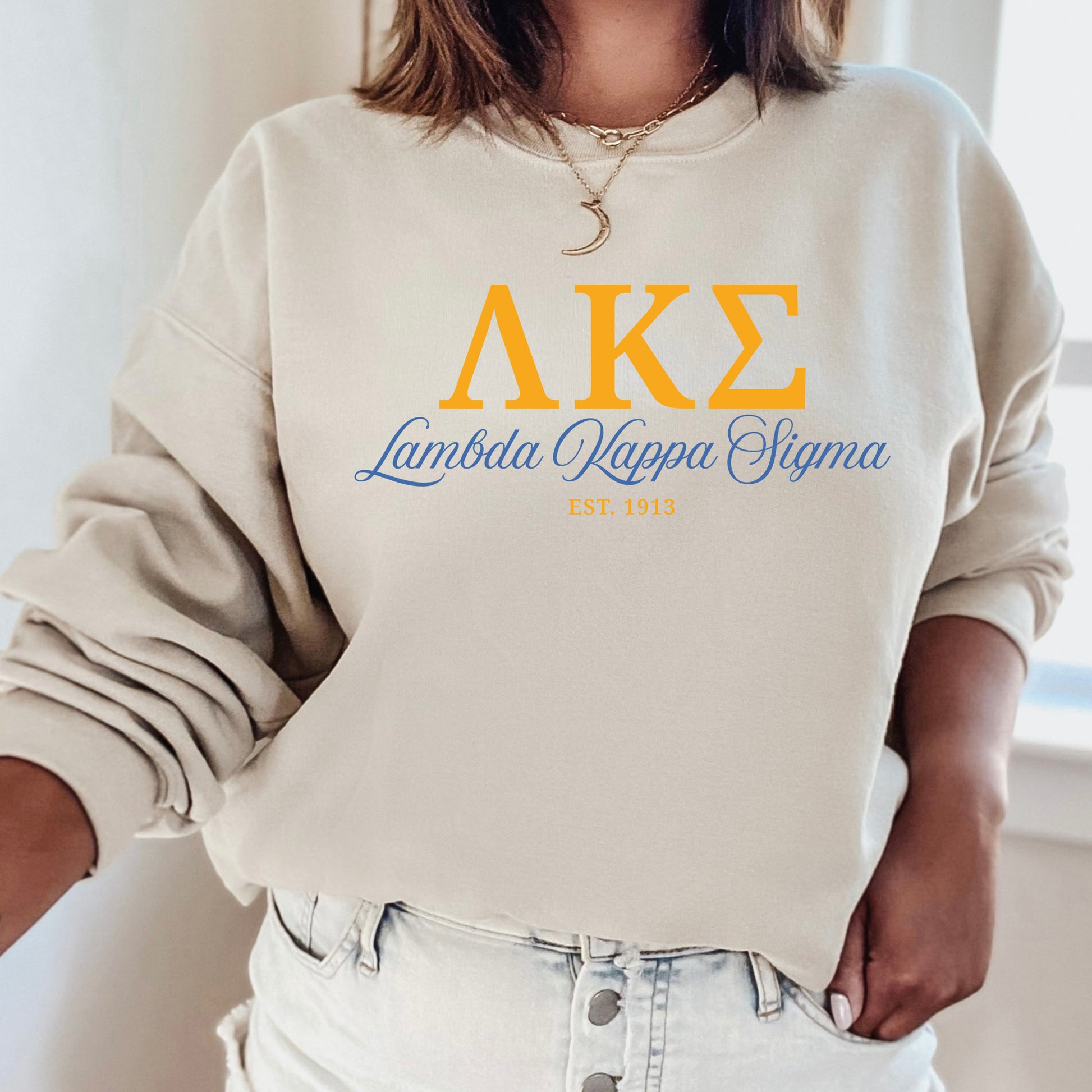 a woman wearing a sweatshirt that says ake