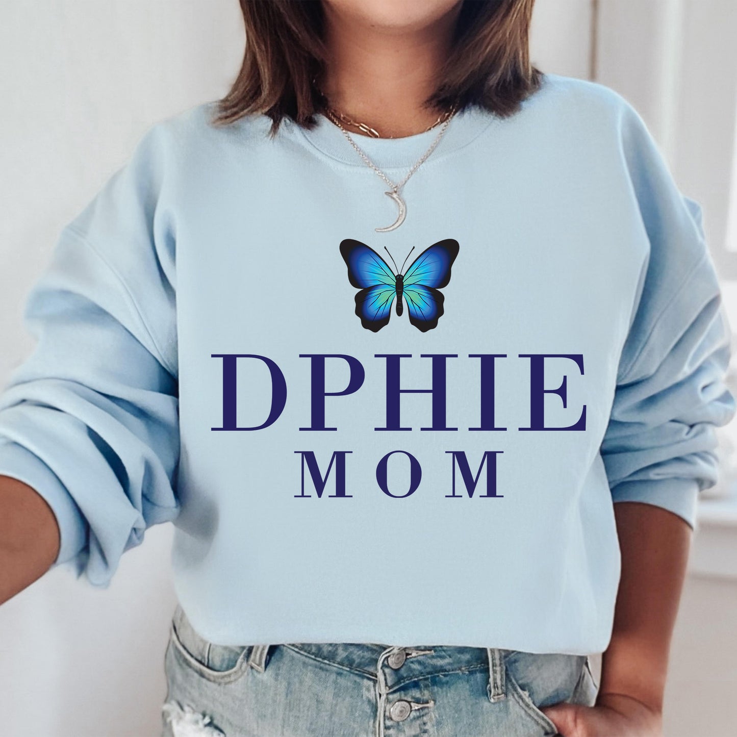a woman wearing a blue sweatshirt with a butterfly on it