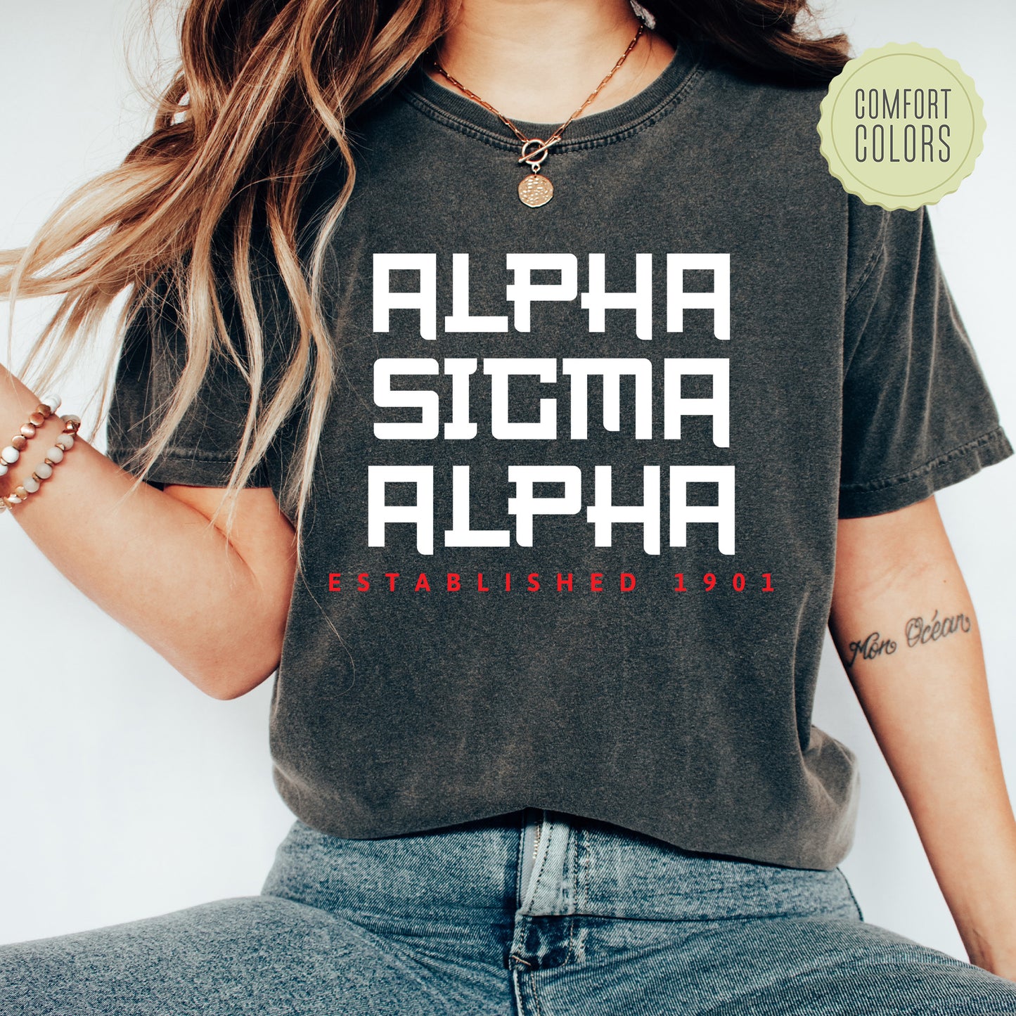 a woman wearing a black shirt with the words alphia, stigmaa,