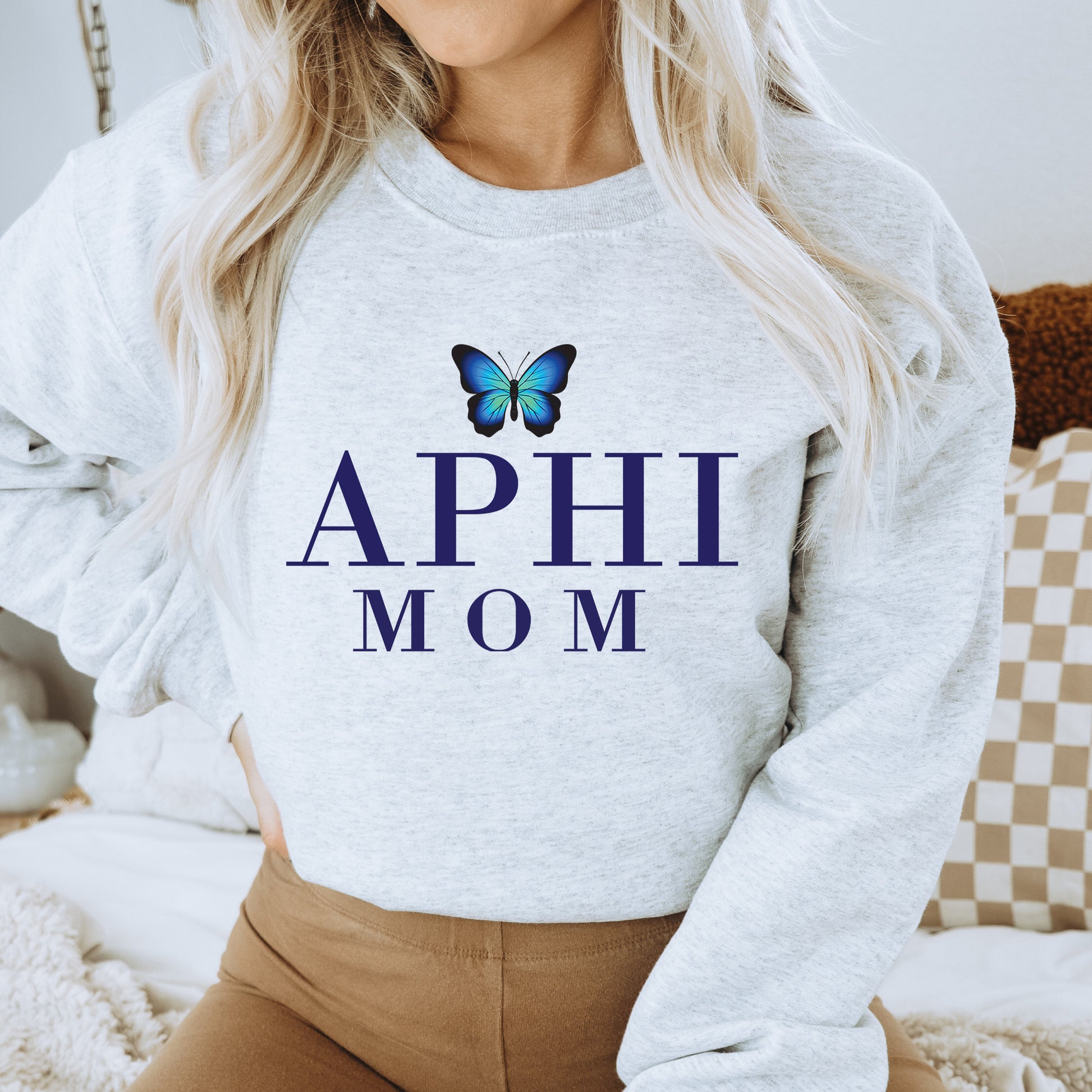 a woman wearing a sweatshirt with a butterfly on it