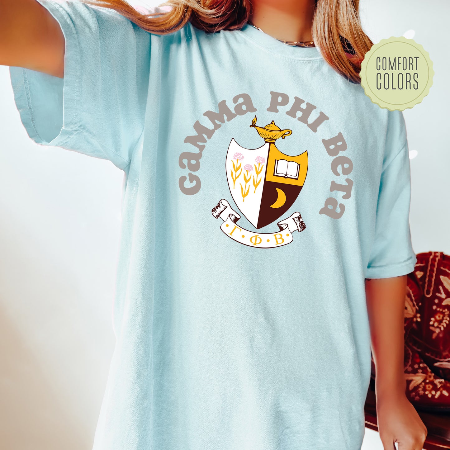 a woman wearing a blue shirt with a crest on it
