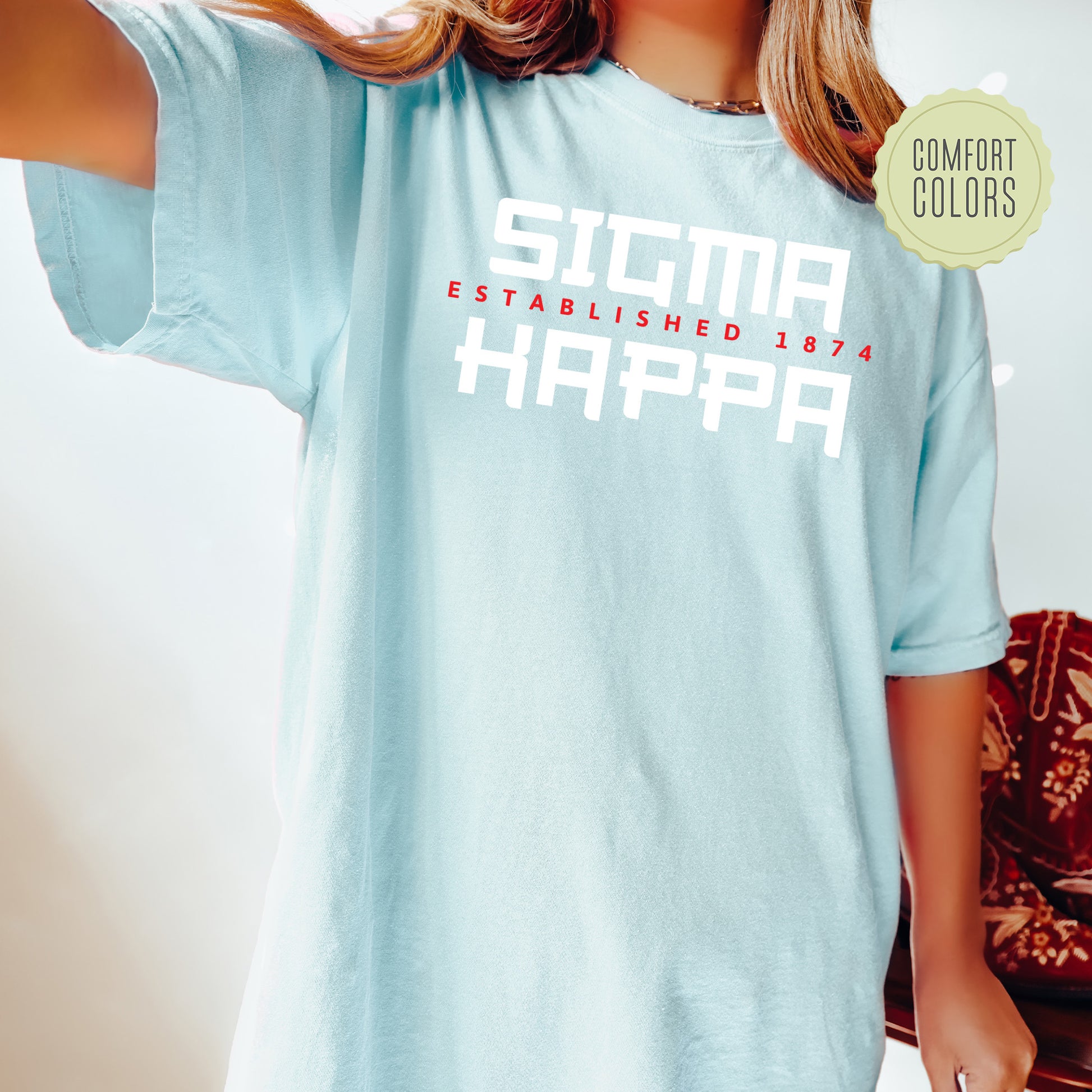 a woman wearing a light blue shirt that says stigma established in harper