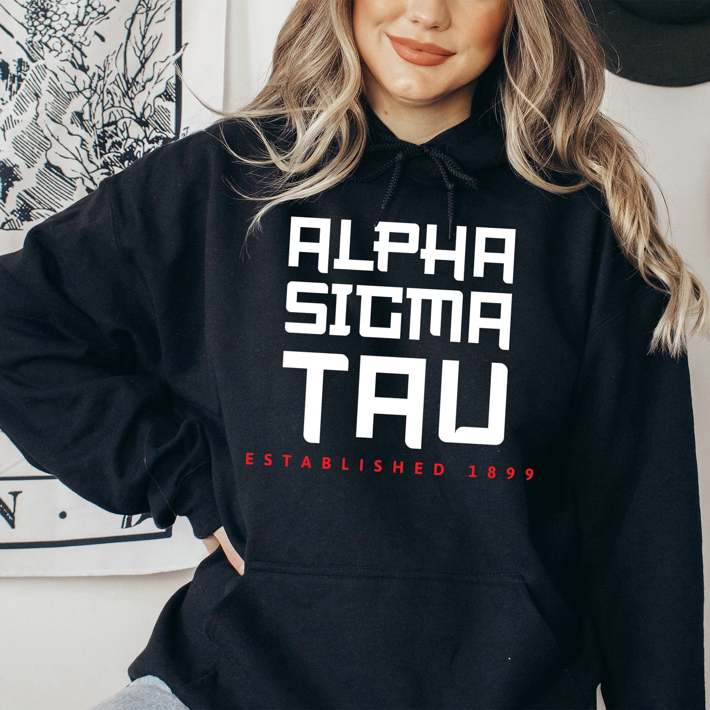 a woman wearing a black hoodie with white letters