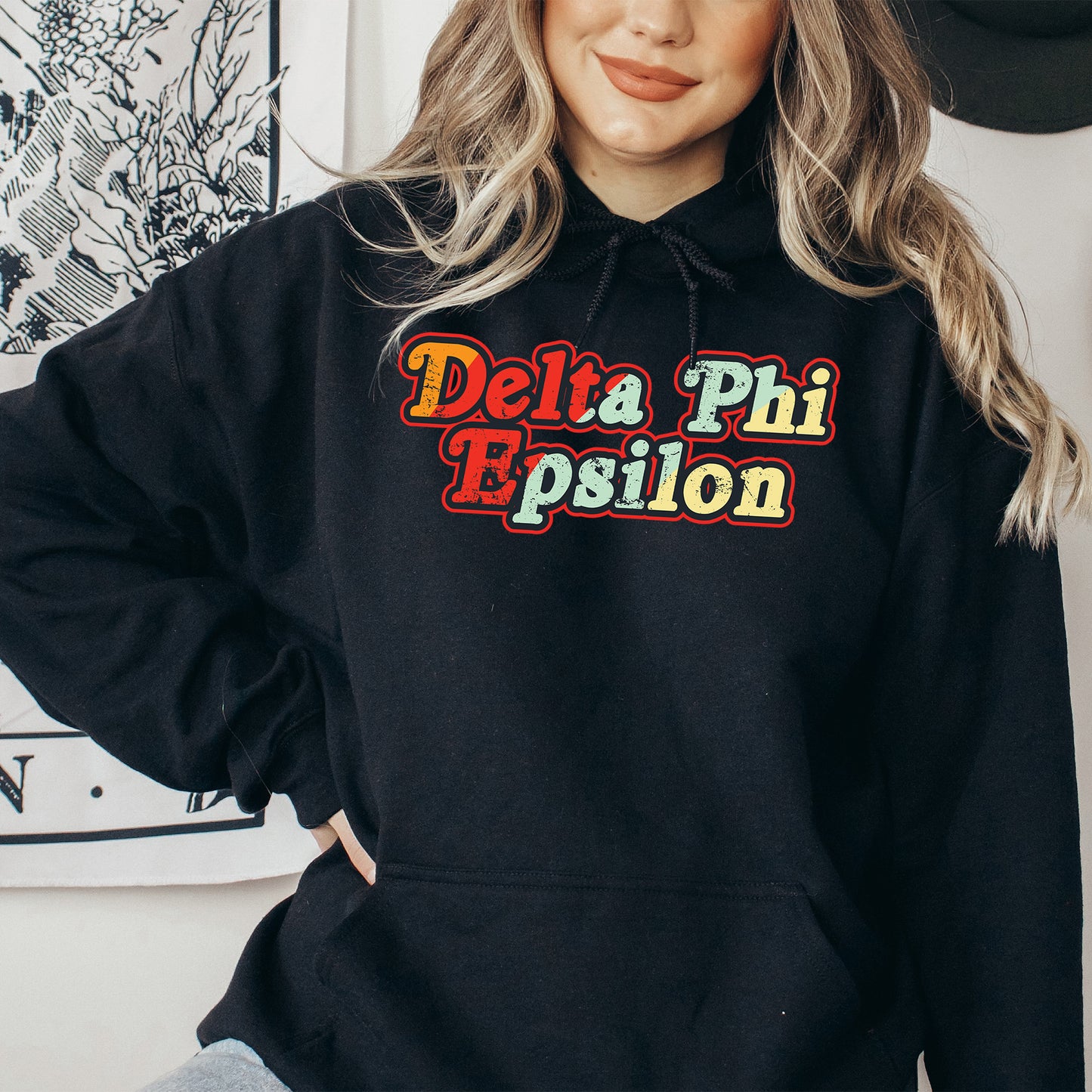 a woman wearing a black hoodie that says delta phi epiloon