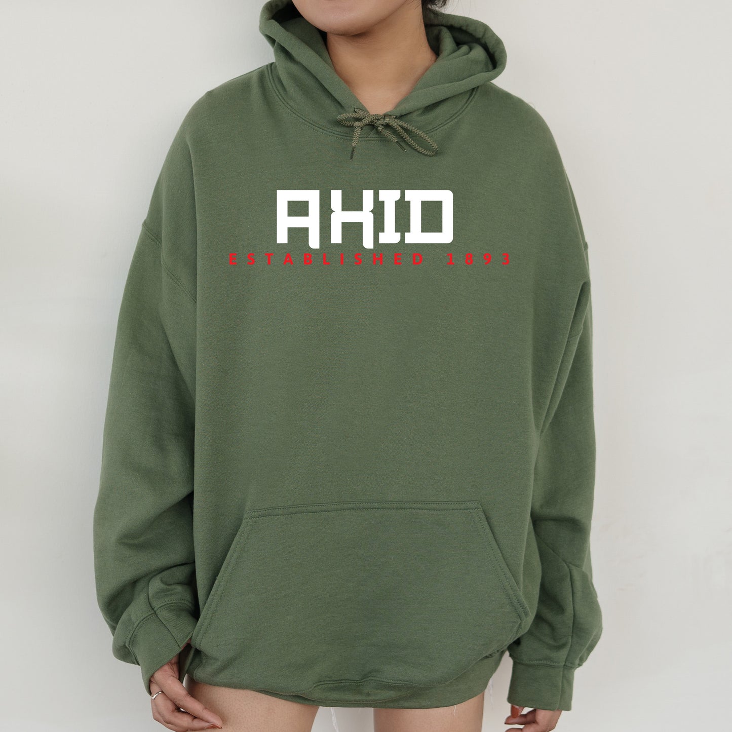 a woman wearing a green hoodie with the words ahd on it