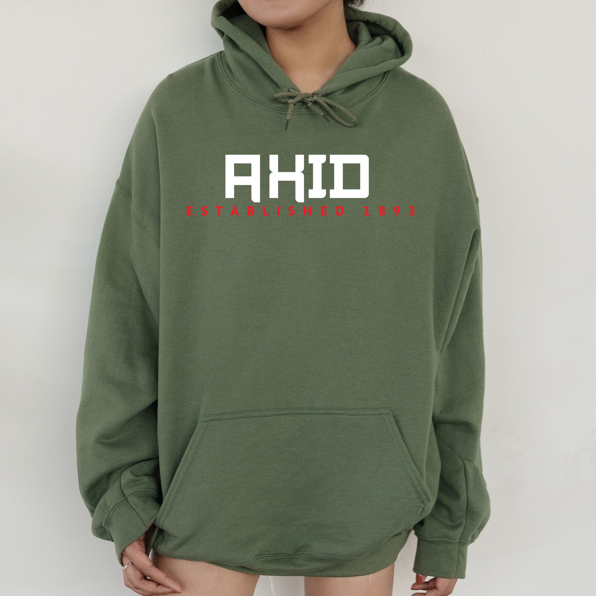 a woman wearing a green hoodie with the words ahd on it