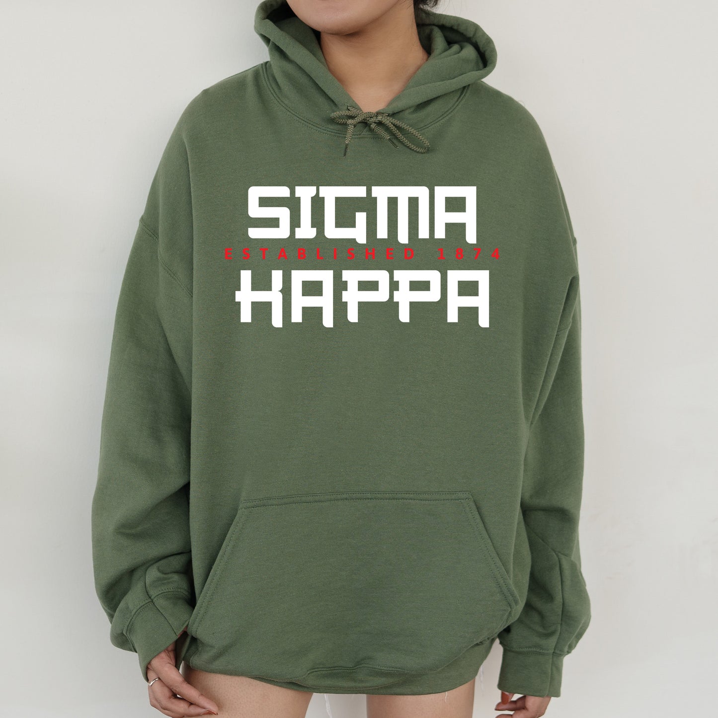 a person wearing a green hoodie that says stigma happa