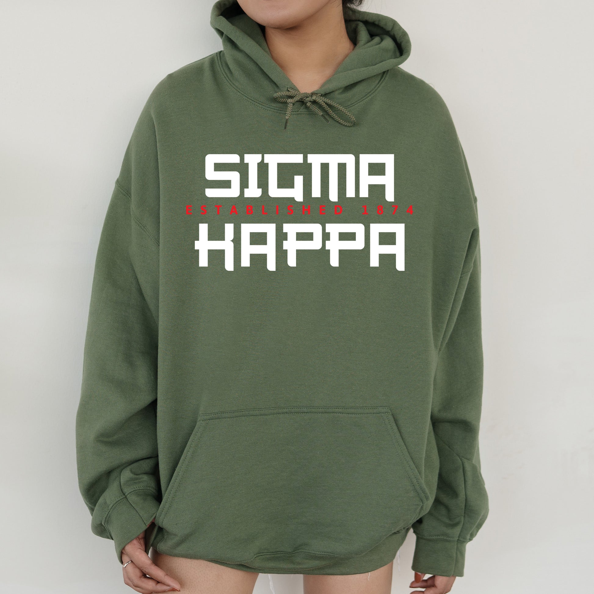a person wearing a green hoodie that says stigma happa