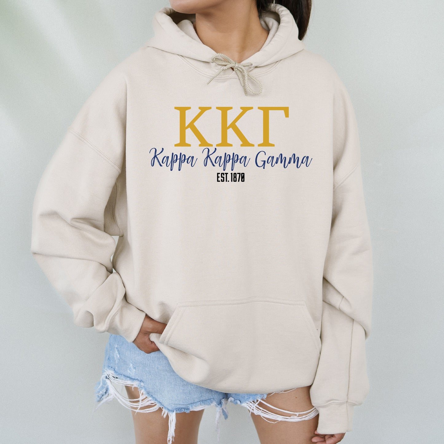 a woman wearing a kkt sweatshirt with the kkt logo on it