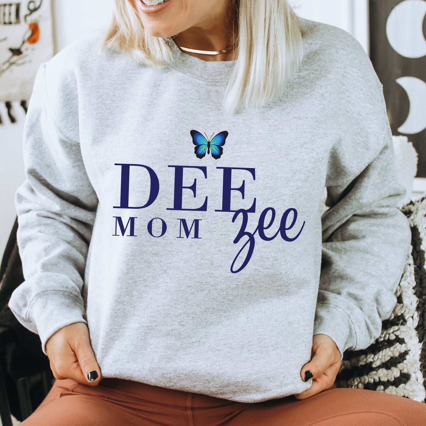 a woman wearing a sweatshirt that says deef mom gee