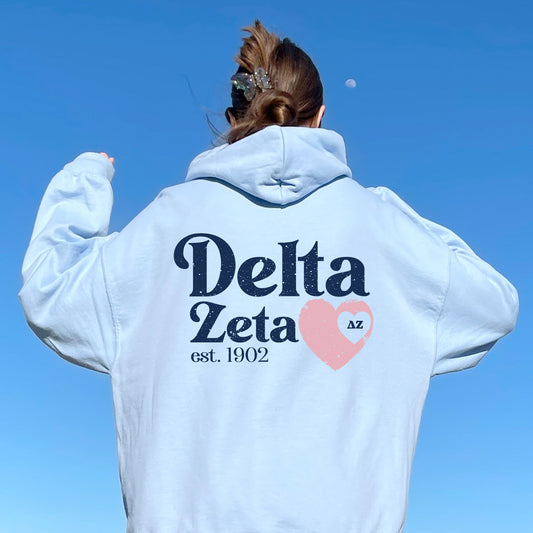 a woman wearing a white delta delta hoodie