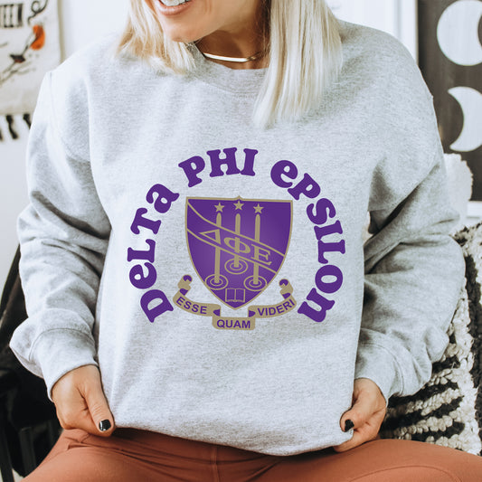 a woman sitting on a chair wearing a sweatshirt