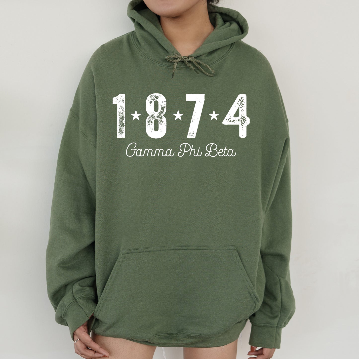 a woman wearing a green hoodie with the number 474 on it