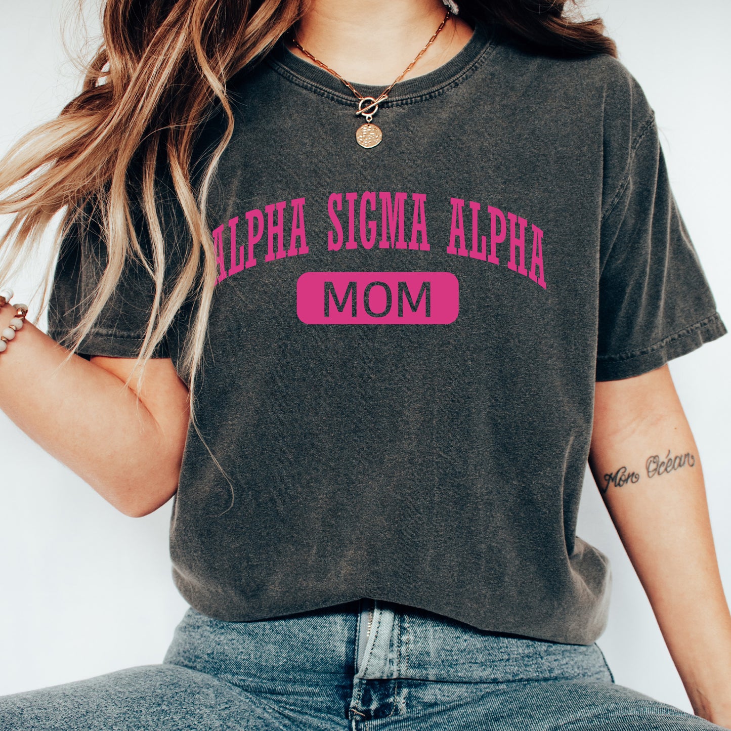 a woman wearing a black shirt with pink letters on it