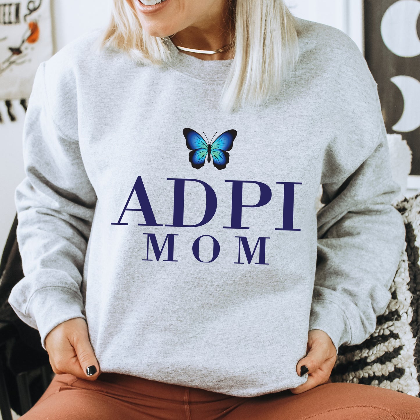 a woman wearing a sweatshirt with a butterfly on it