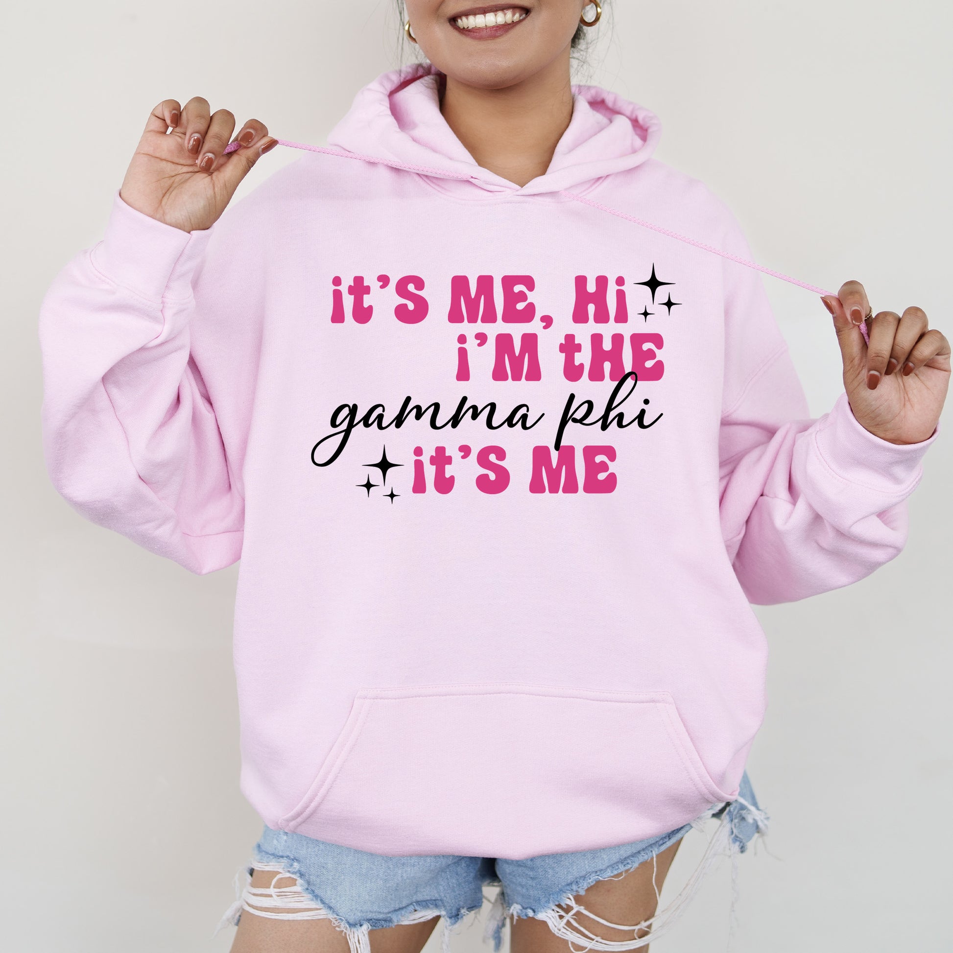 a woman wearing a pink hoodie that says it's me, i '
