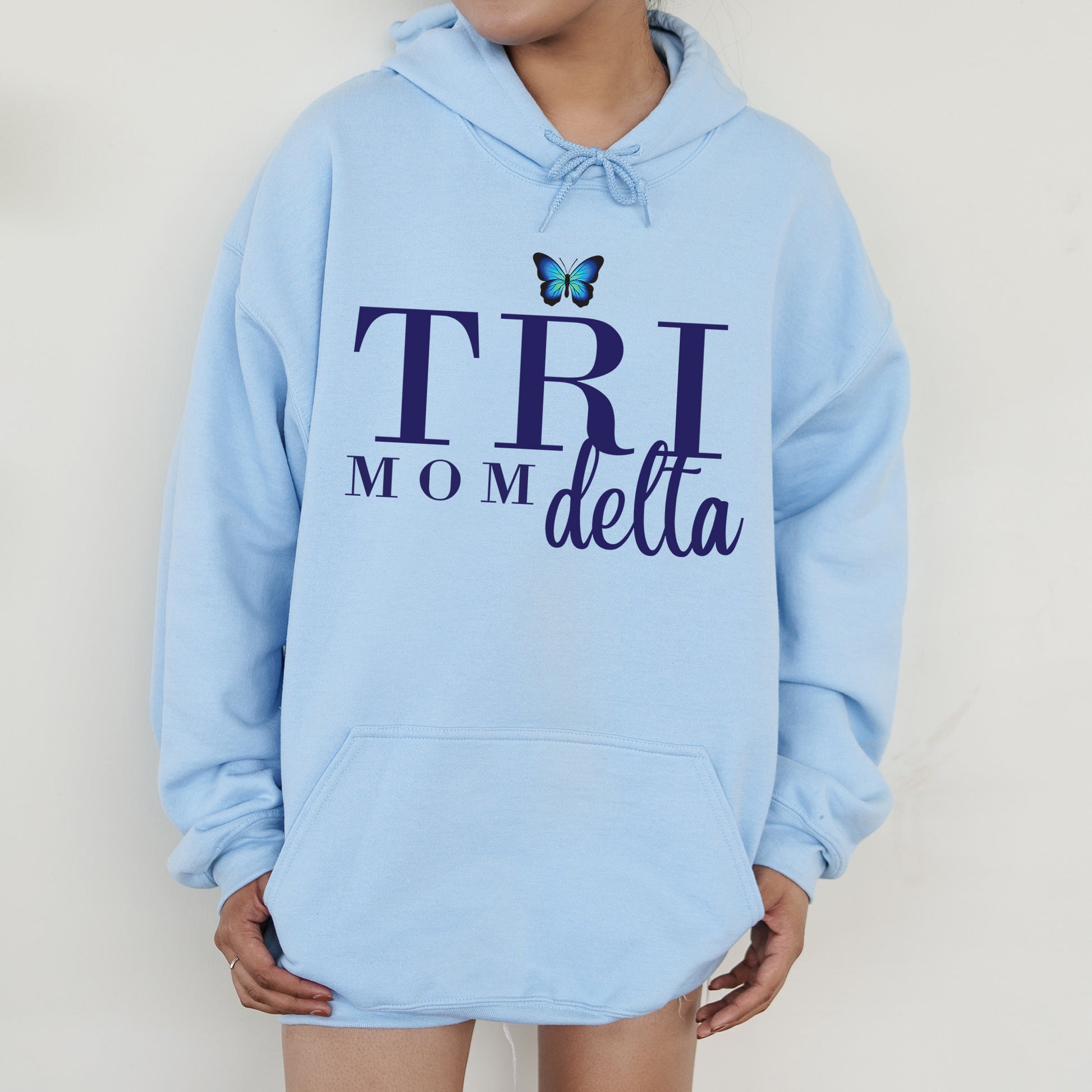 a woman wearing a blue hoodie with a butterfly on it