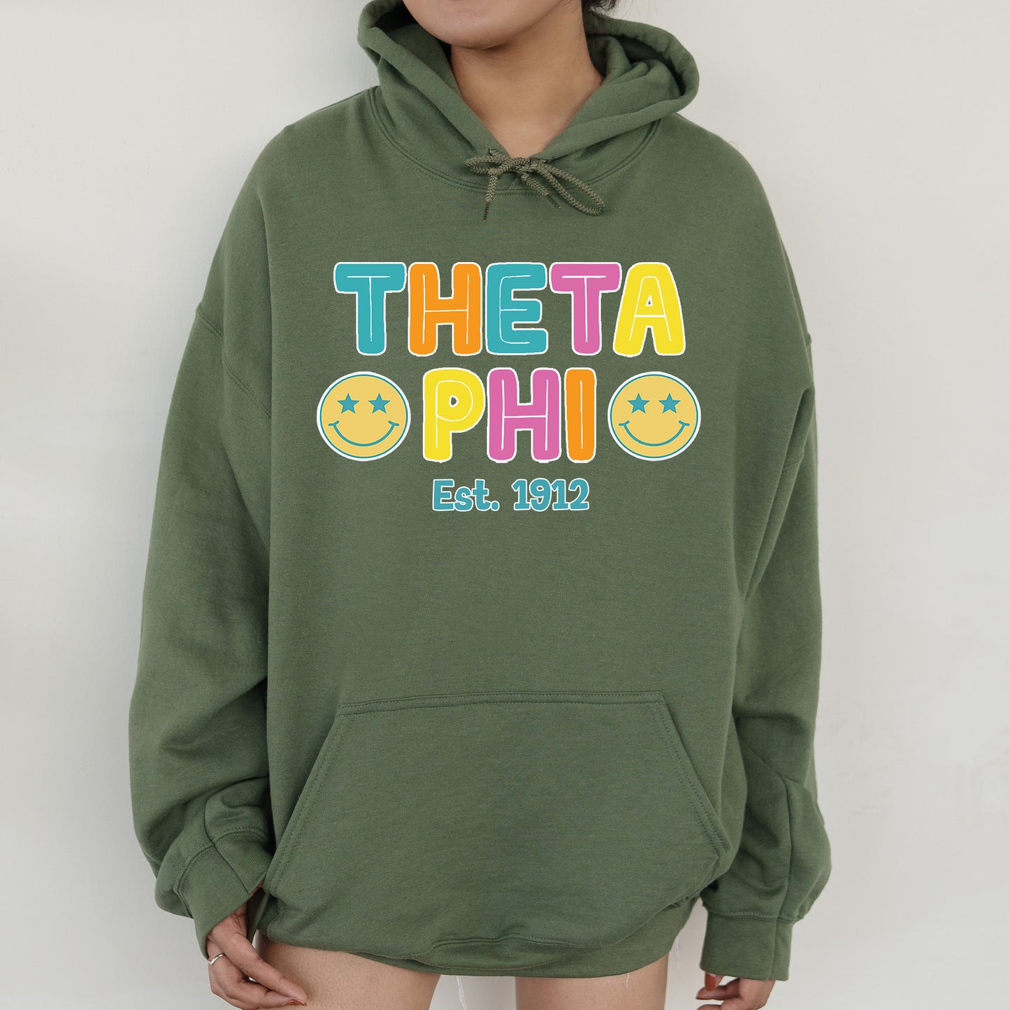 a woman wearing a green hoodie with the words thea ophi on it