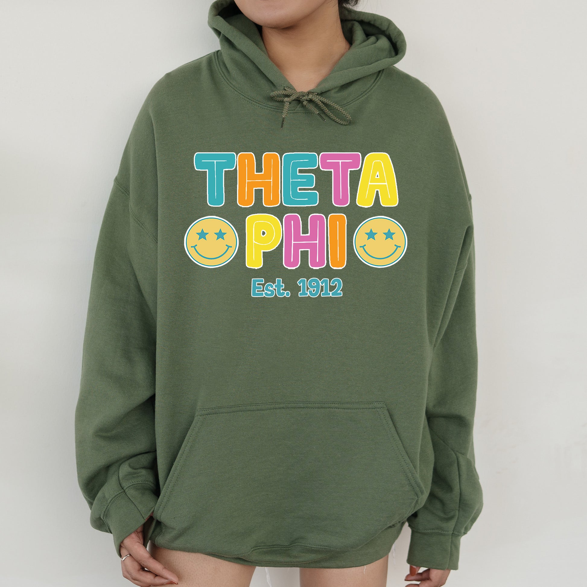 a woman wearing a green hoodie with the words thea ophi on it