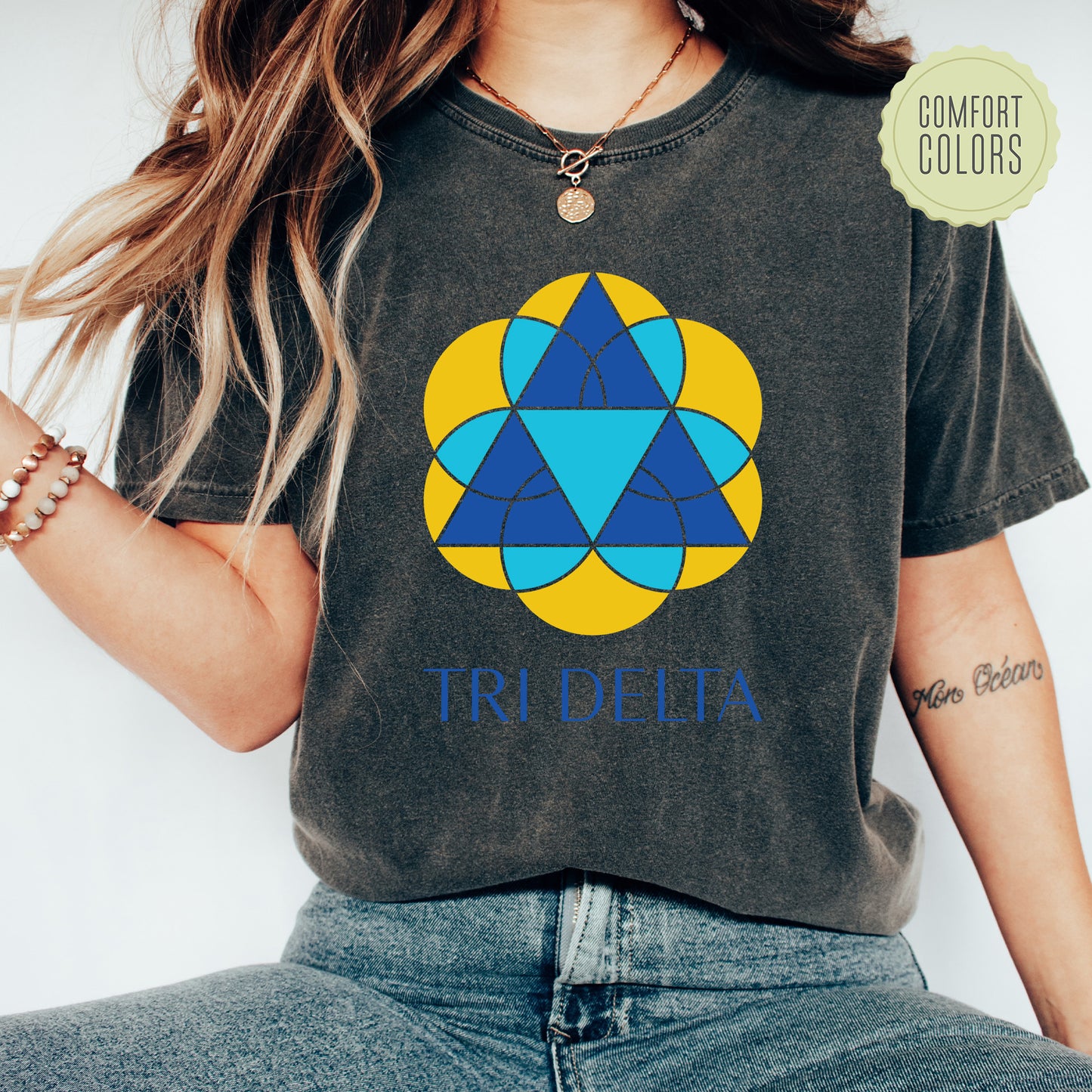 a woman wearing a t - shirt with a tri - delta design on it