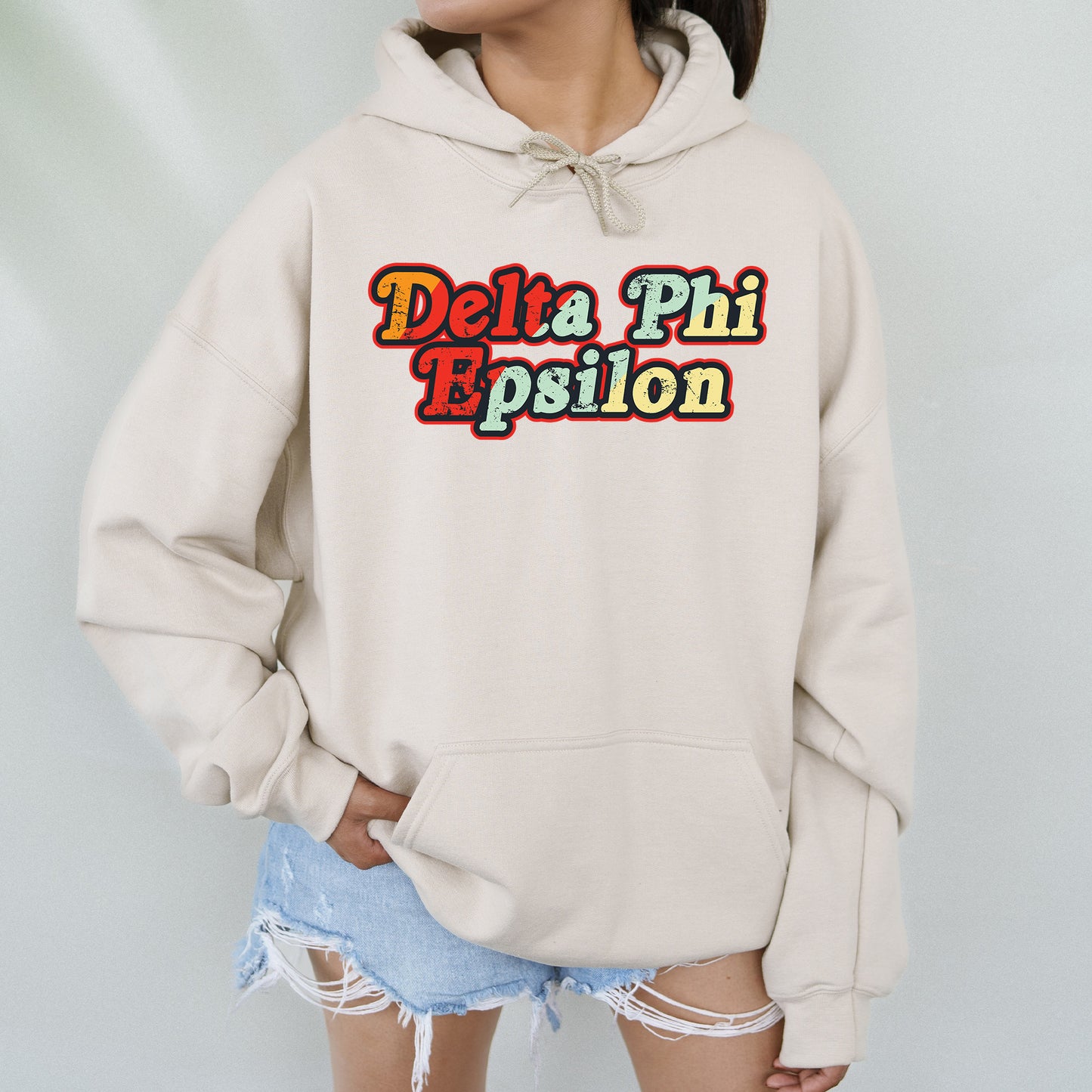 a woman wearing a sweatshirt that says delta phi espion