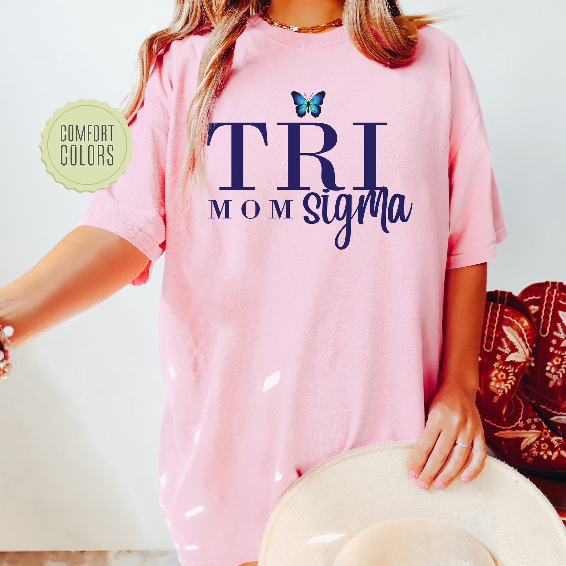 a woman wearing a pink shirt with a butterfly on it