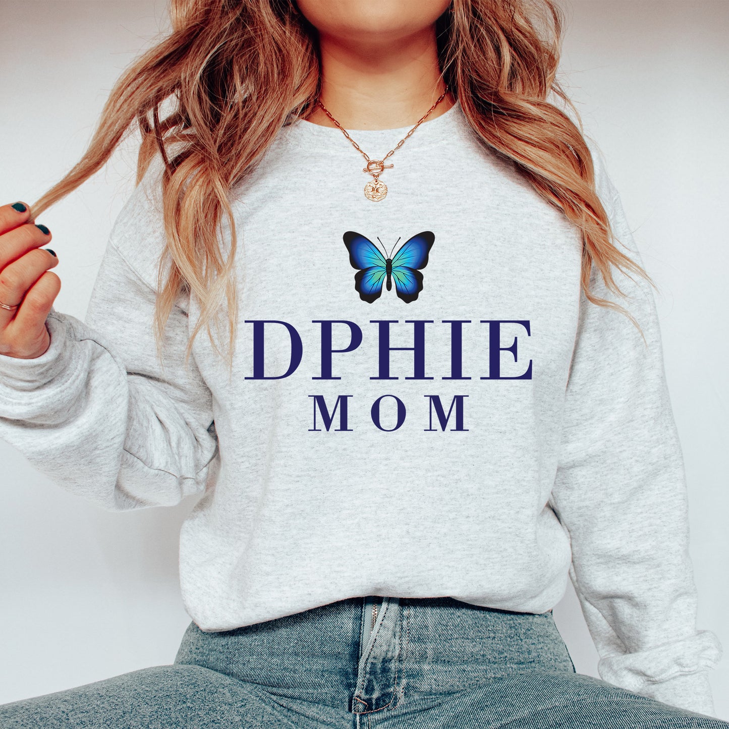 a woman wearing a sweatshirt with a butterfly on it