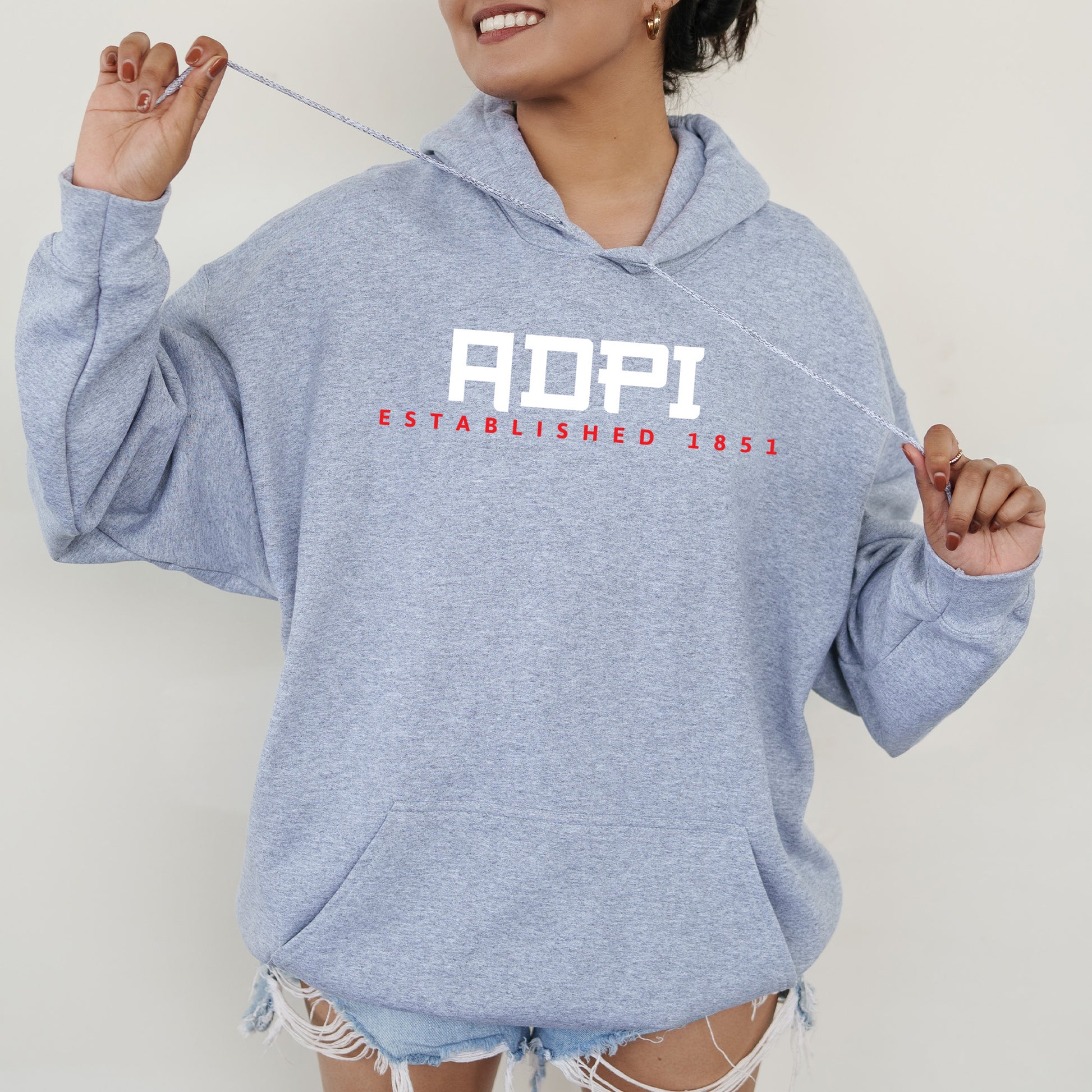 a woman in a blue hoodie is holding a string