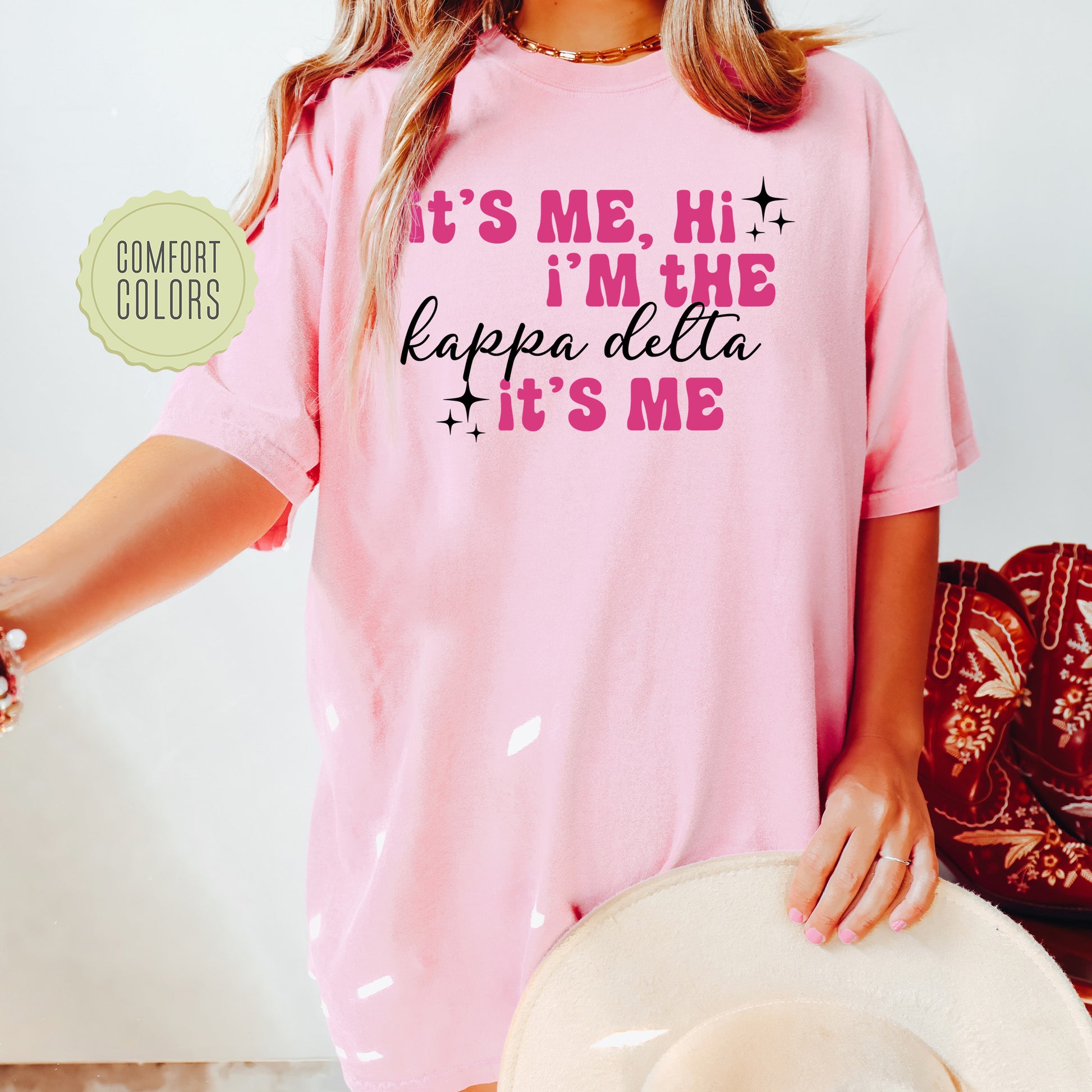 a woman wearing a pink shirt and hat
