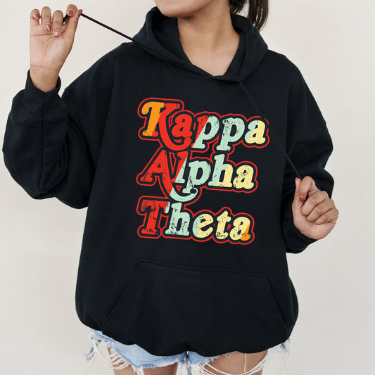 a woman wearing a black hoodie with the words kapppa alpha the