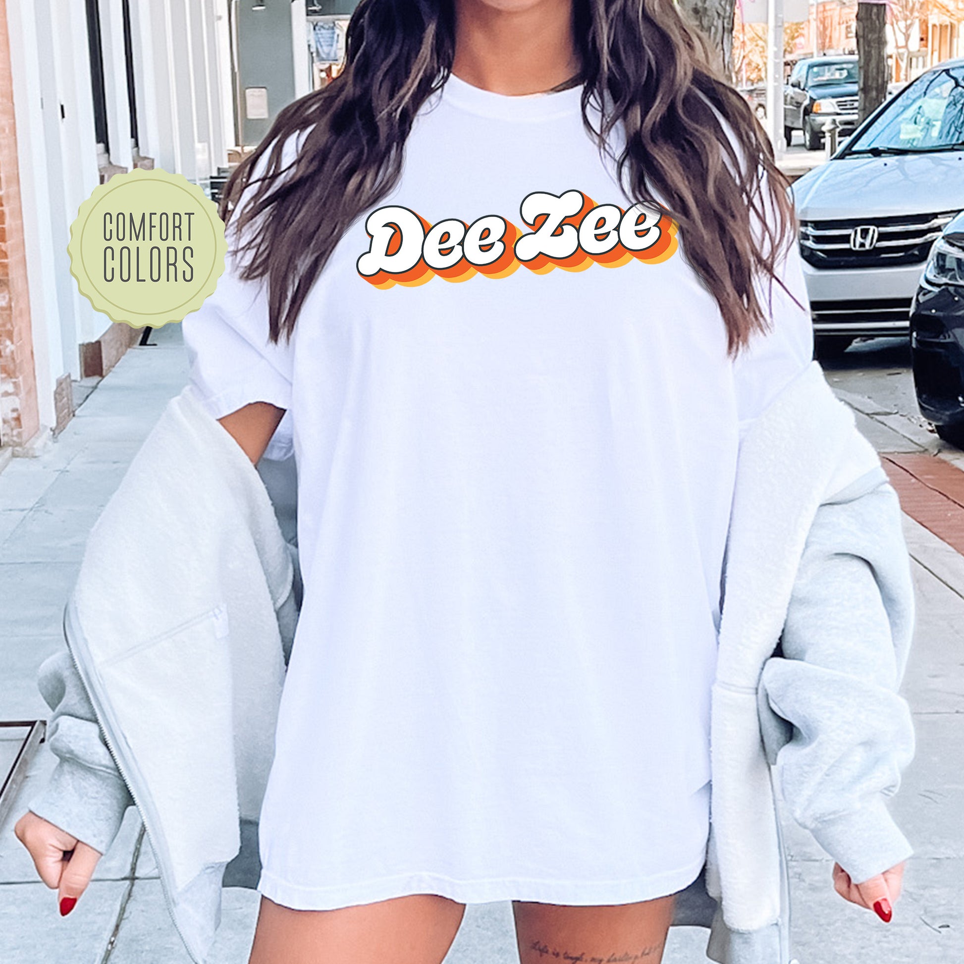 a woman wearing a white shirt with the word dee dee on it